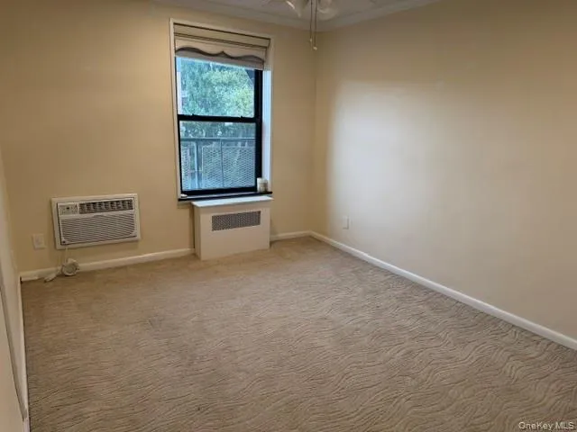 Window with a window unit air conditioner and a radiator cover Window with a window unit air conditioner and a radiator cover