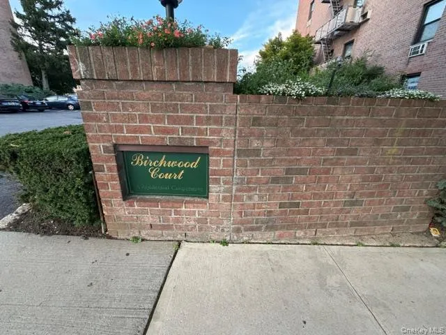 Brick entryway with integrated planter and signage Brick entryway with integrated planter and signage