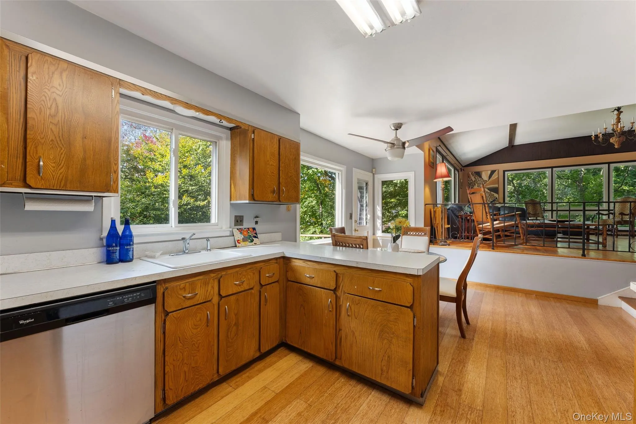 Kitchen featuring wood cabinetry, solid surface countertops, and a ceiling fan. Kitchen featuring wood cabinetry, solid surface countertops, and a ceiling fan.