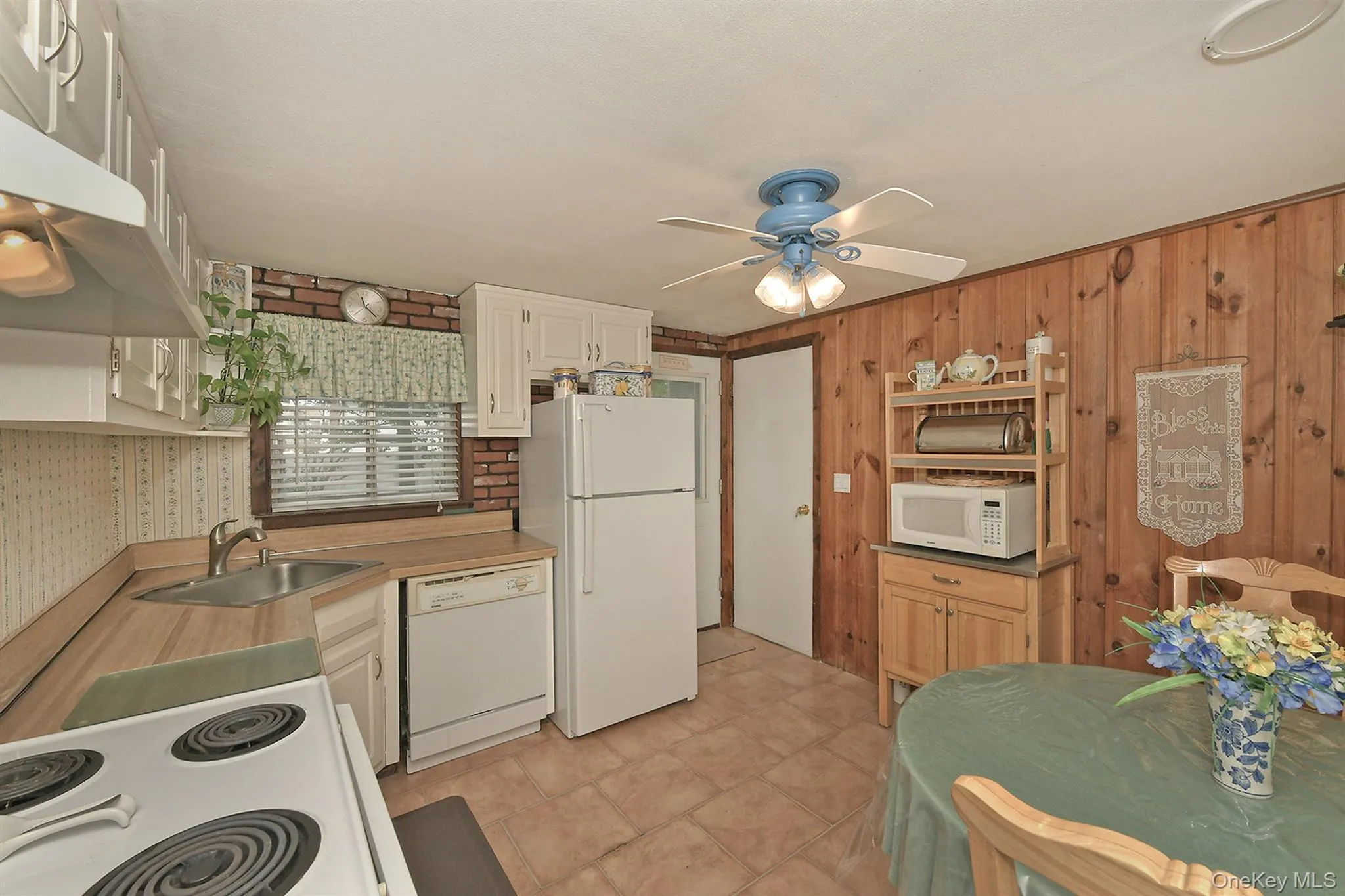 Lower Level Eat in Kitchen, Electric Stove, Dishwasher, Refigerator Ceiling Fan. Tiled Floor with access to Laundry Room & Sep. Door to Yard. Lower Level Eat in Kitchen, Electric Stove, Dishwasher, Refigerator Ceiling Fan. Tiled Floor with access to Laundry Room & Sep. Door to Yard.