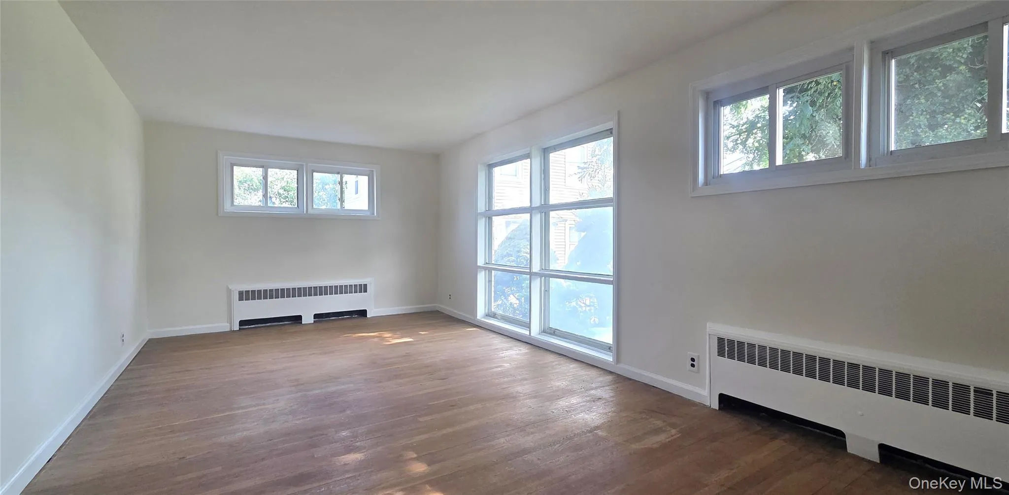 Living room has hardwood flooring and picture window Living room has hardwood flooring and picture window