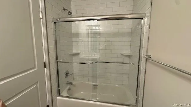 Bathroom with shower / bath combination with glass door Bathroom with shower / bath combination with glass door