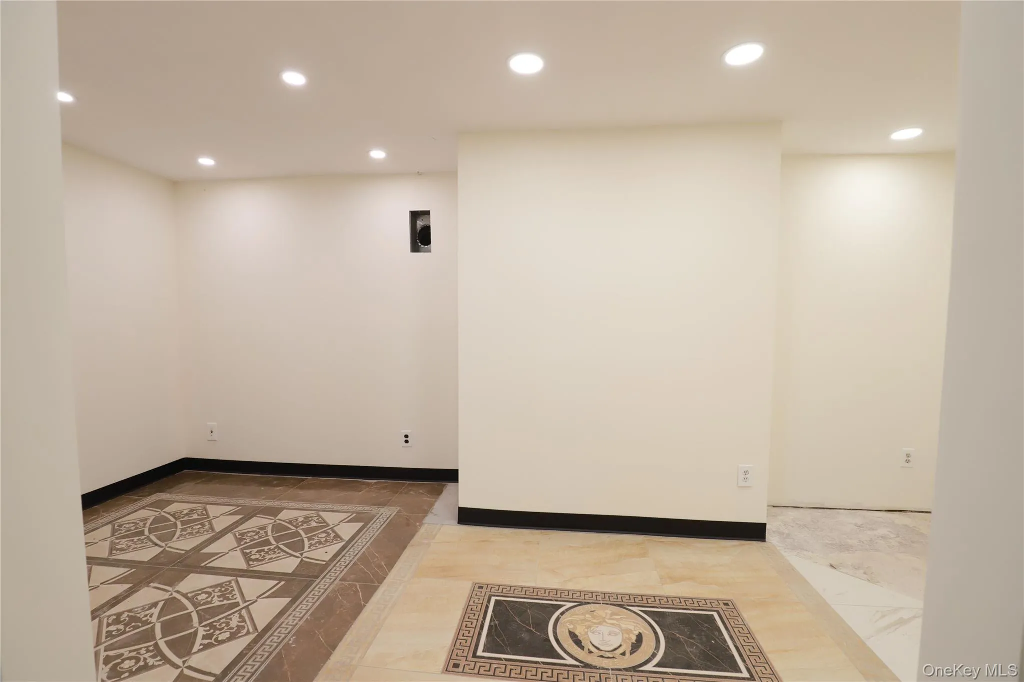 Recessed lighting throughout, accent tile flooring, and light-toned walls Recessed lighting throughout, accent tile flooring, and light-toned walls