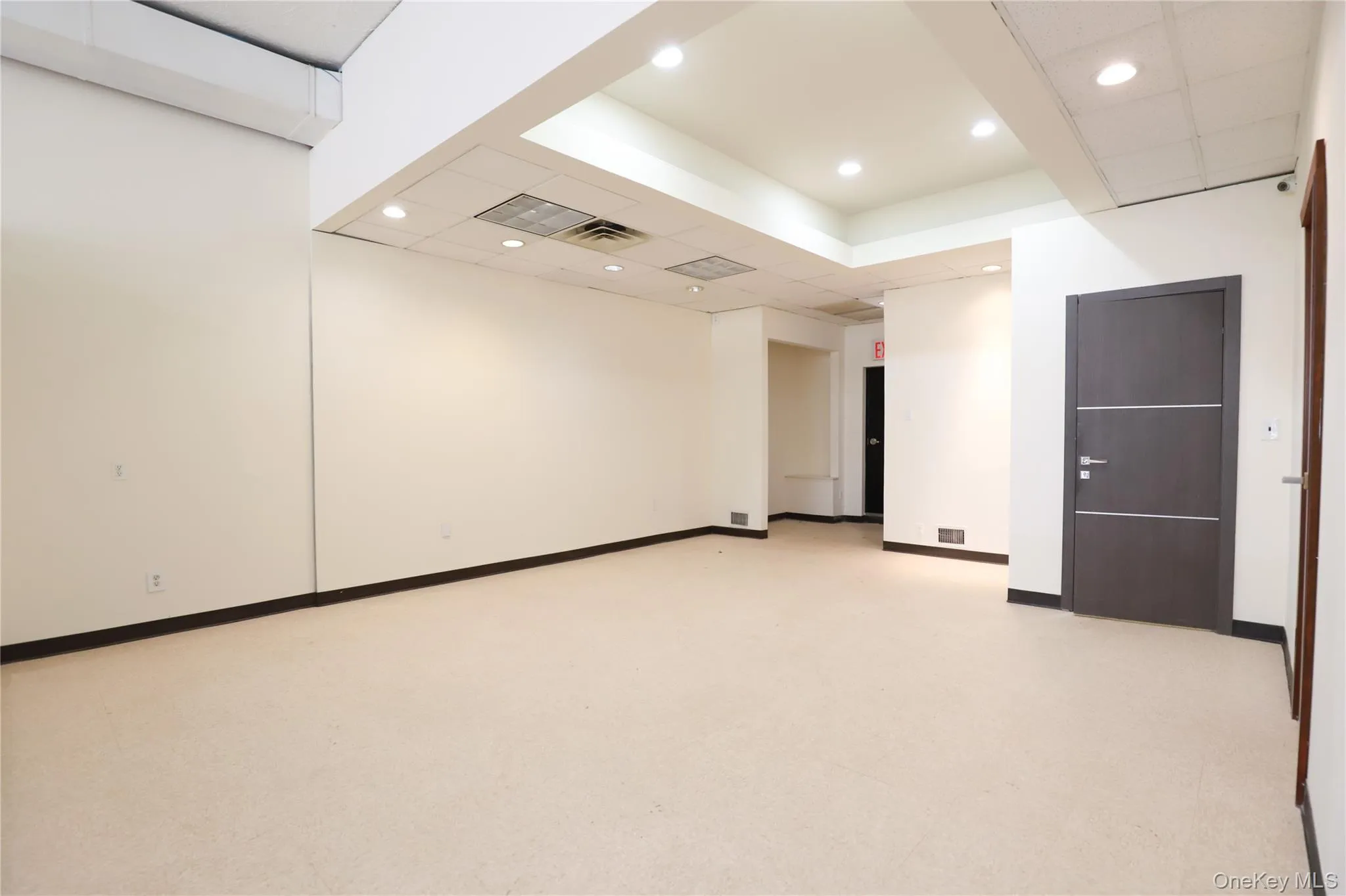 Spacious open floor plan with pristine neutral carpeting, recessed ceiling lighting, and modern architectural finishes Spacious open floor plan with pristine neutral carpeting, recessed ceiling lighting, and modern architectural finishes