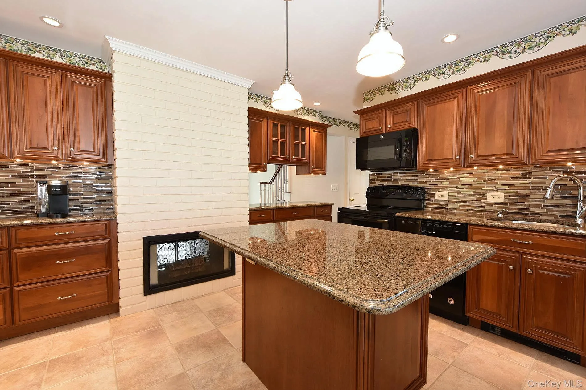 Kitchen with an Island & Double Sided Fireplace Kitchen with an Island & Double Sided Fireplace