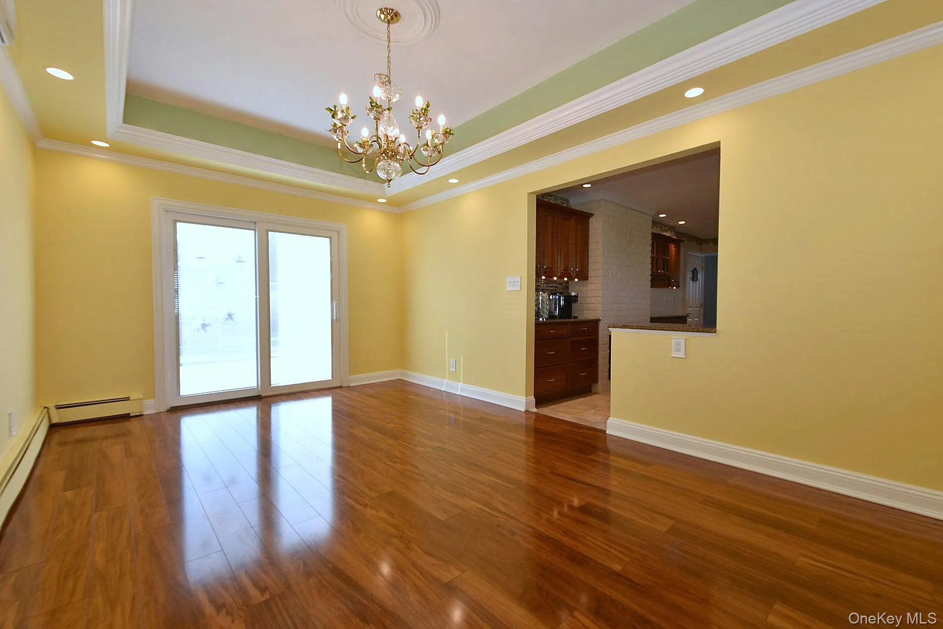 Dining Room with a tray ceiling & sliding door to the back yard. Dining Room with a tray ceiling & sliding door to the back yard.