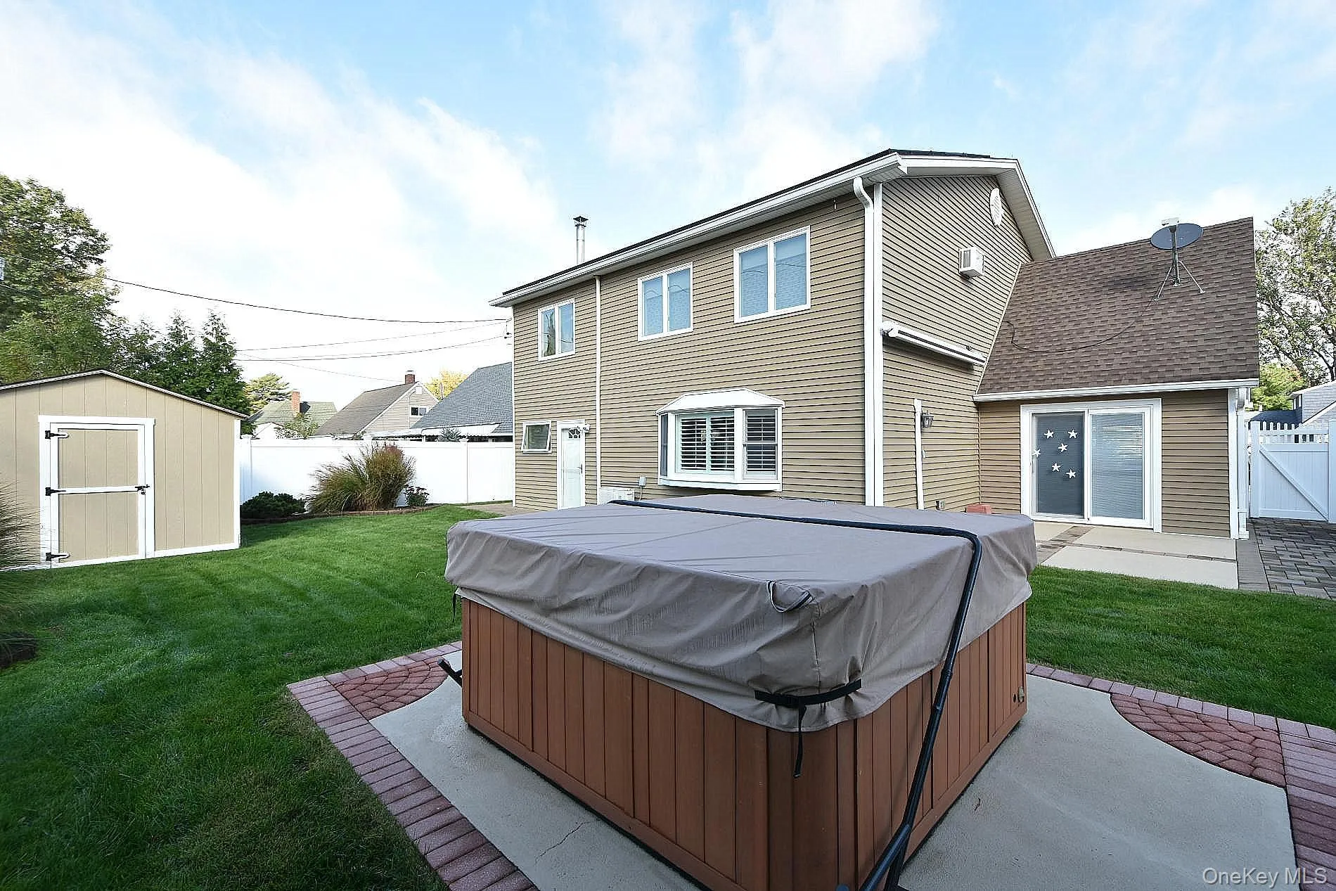 Backyard with hot tub and automated awning Backyard with hot tub and automated awning