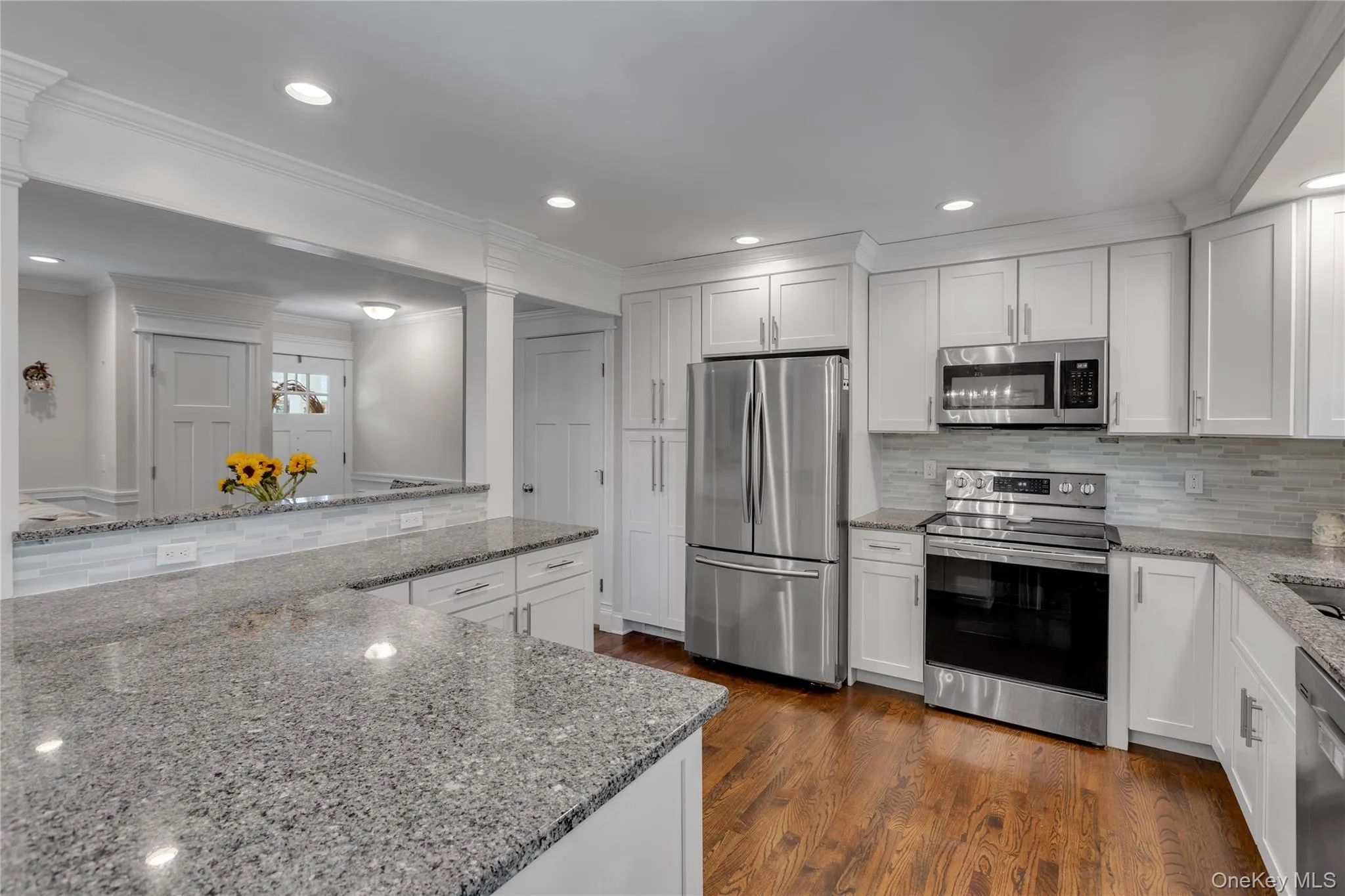 Granite countertops, white shaker cabinetry, stainless steel appliances, wood-finish flooring, and recessed lighting Granite countertops, white shaker cabinetry, stainless steel appliances, wood-finish flooring, and recessed lighting