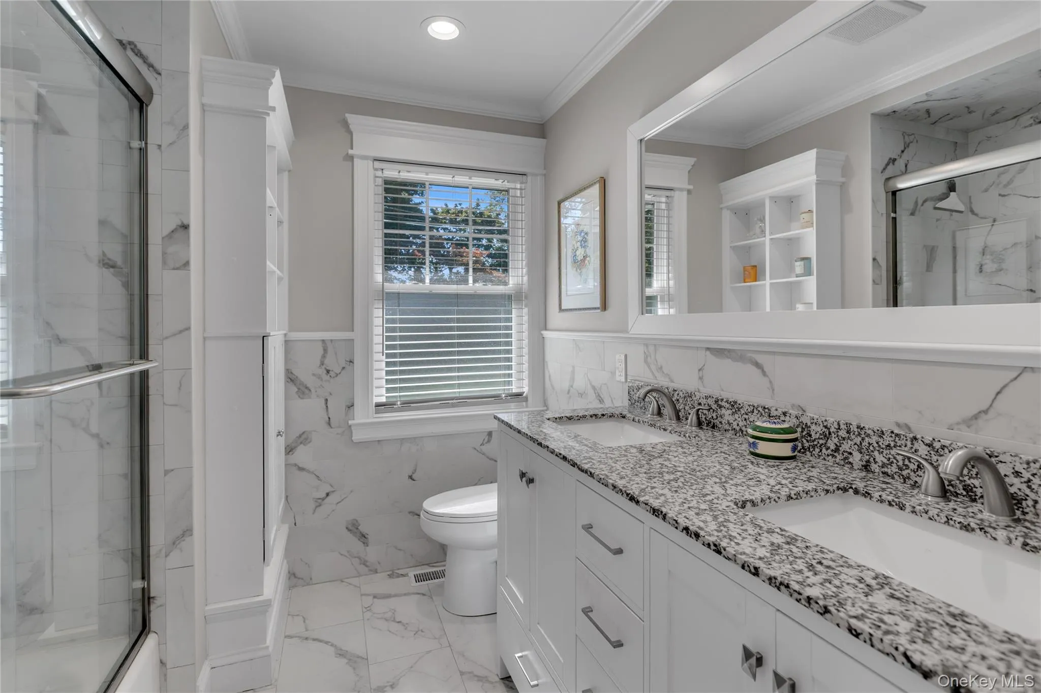 Dual vanity with granite countertops, undermount sinks, and brushed nickel fixtures Dual vanity with granite countertops, undermount sinks, and brushed nickel fixtures