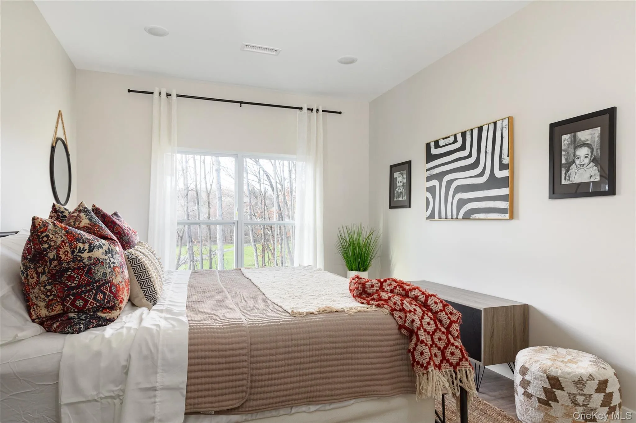 Recessed lighting, large window with outdoor scenery, light-toned walls. Recessed lighting, large window with outdoor scenery, light-toned walls.
