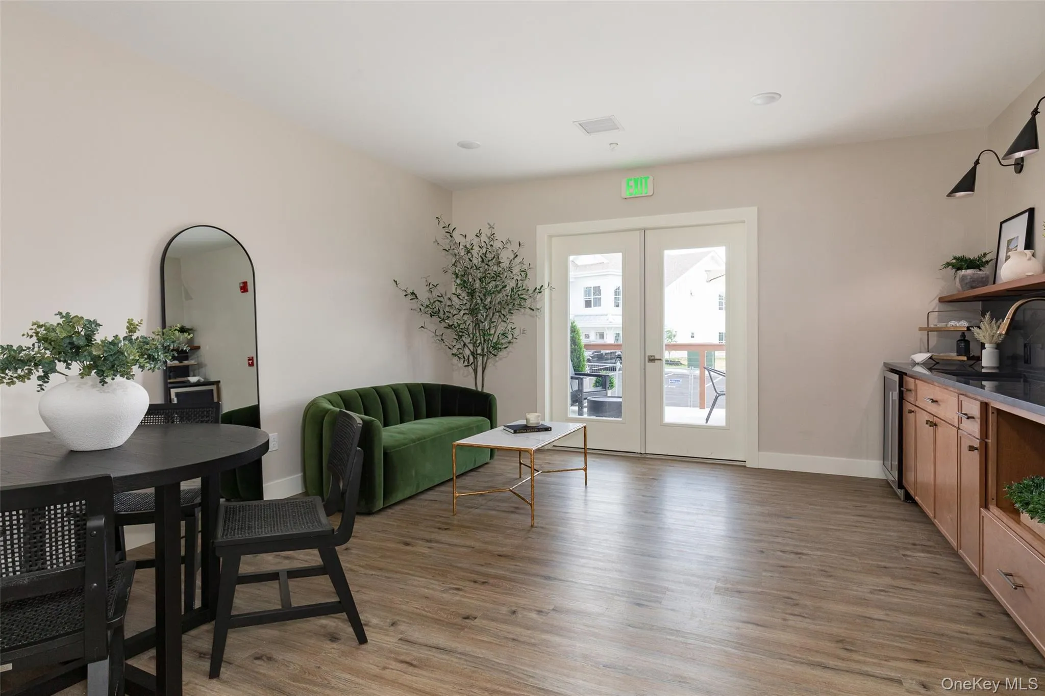 Community lounge with wood-finish flooring, recessed lighting, and a built-in counter with wood cabinetry. Community lounge with wood-finish flooring, recessed lighting, and a built-in counter with wood cabinetry.
