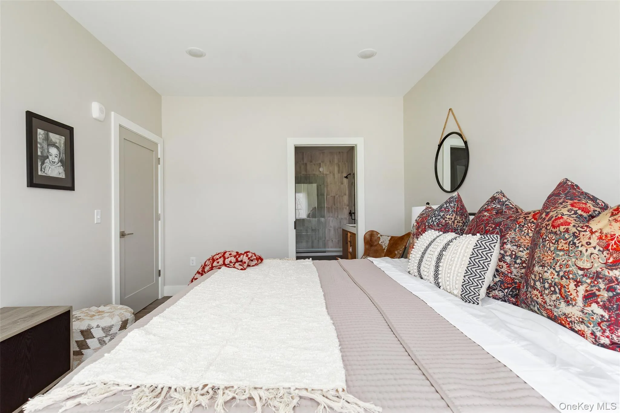 Recessed ceiling lighting, light neutral wall color, ensuite bathroom with walk-in closet. Recessed ceiling lighting, light neutral wall color, ensuite bathroom with walk-in closet.