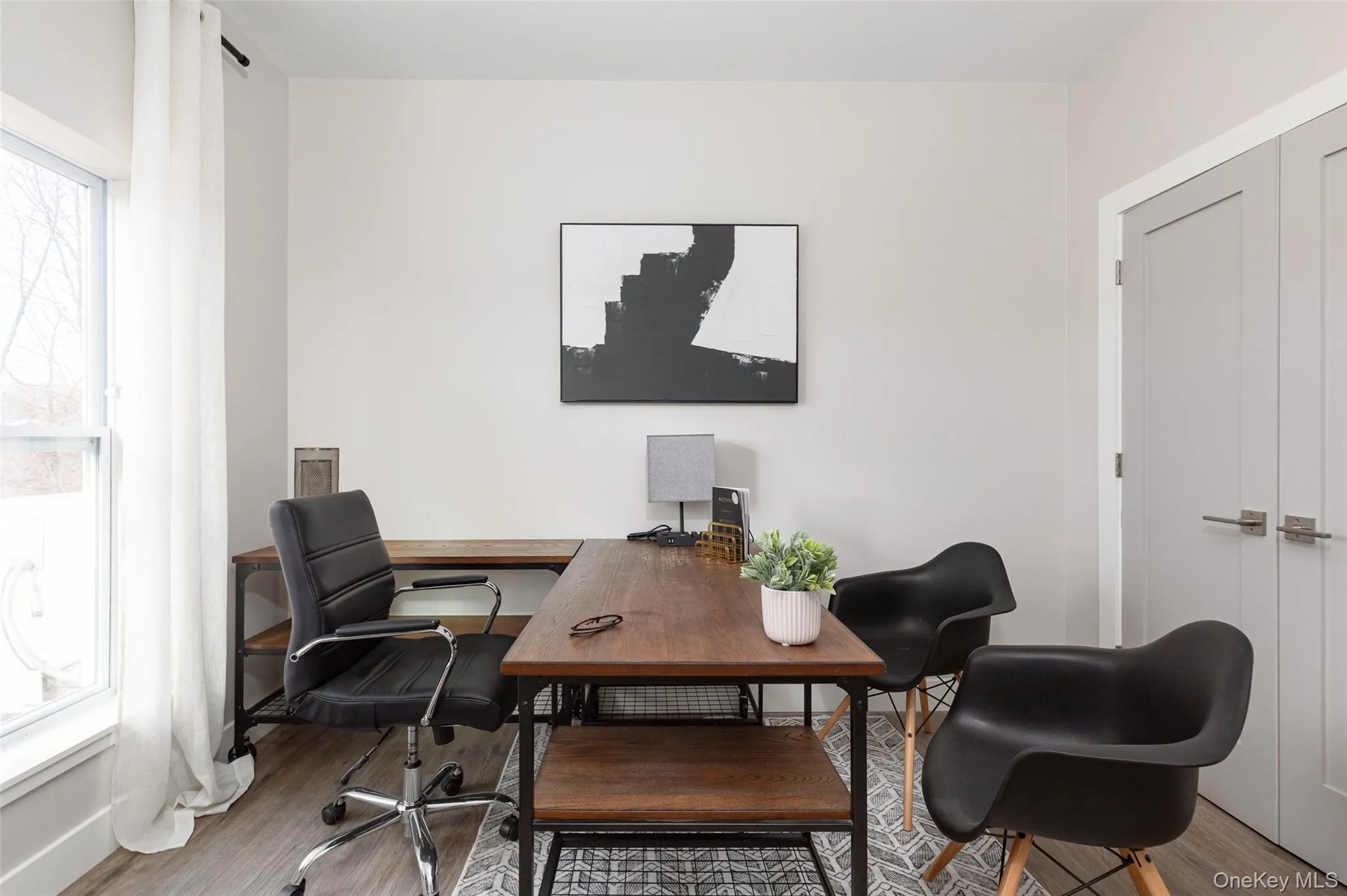 Second bedroom, light-toned walls complement wood-finish flooring. Second bedroom, light-toned walls complement wood-finish flooring.