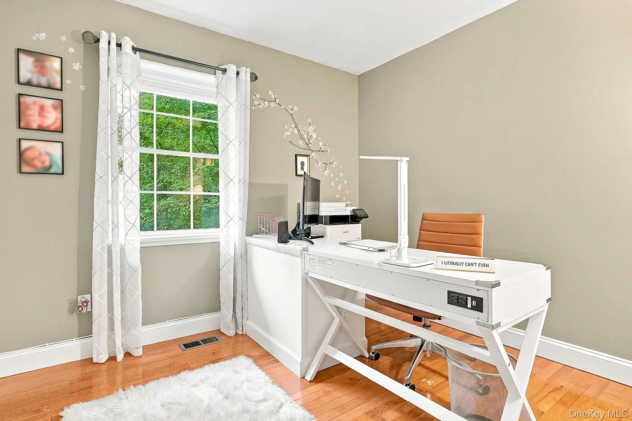 Hardwood flooring, neutral wall paint, white trim, and a multi-pane window Hardwood flooring, neutral wall paint, white trim, and a multi-pane window