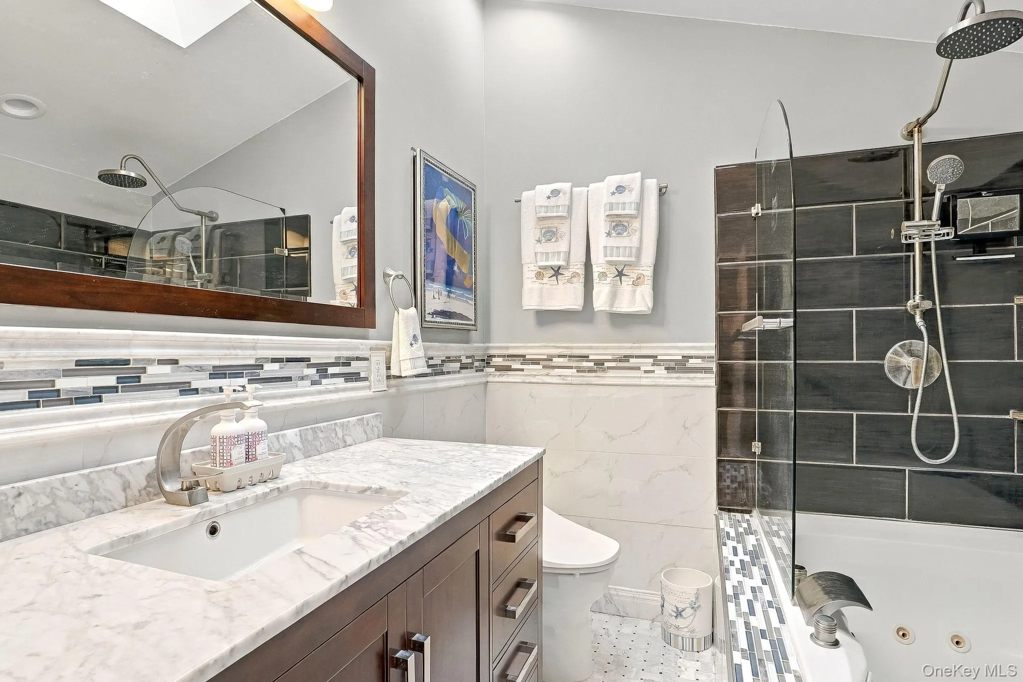 White undermount sink with a single-handle faucet, set into a marble-look countertop White undermount sink with a single-handle faucet, set into a marble-look countertop