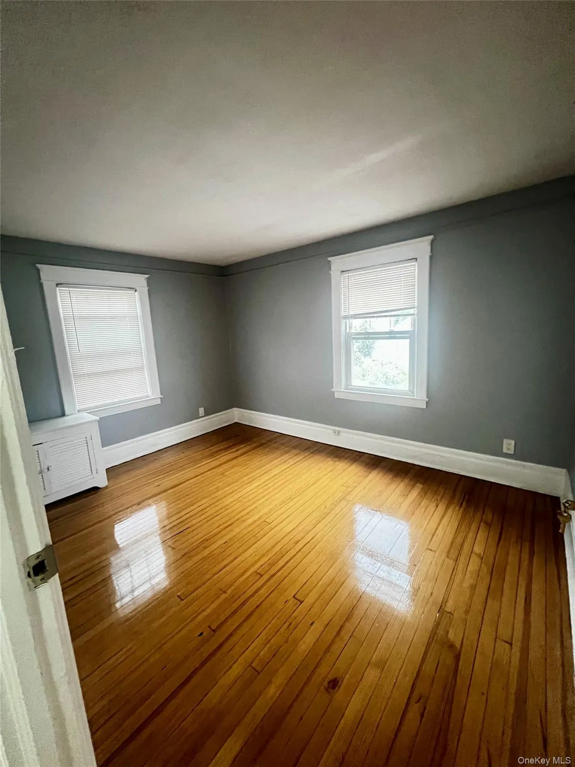 Spare room with baseboards and light wood finished floors Spare room with baseboards and light wood finished floors