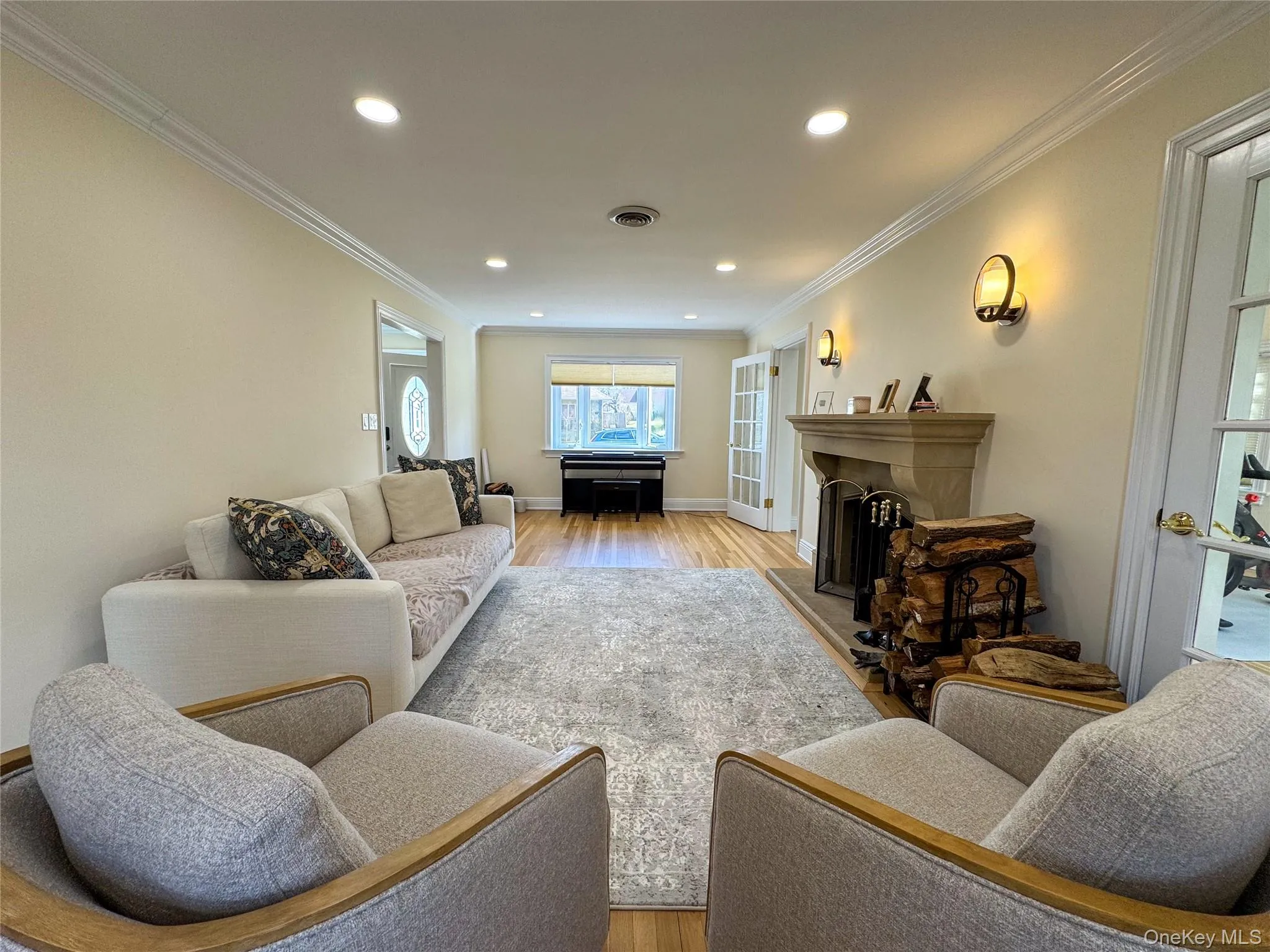 Hardwood flooring, crown molding, recessed lighting, stone fireplace, and double French doors Hardwood flooring, crown molding, recessed lighting, stone fireplace, and double French doors