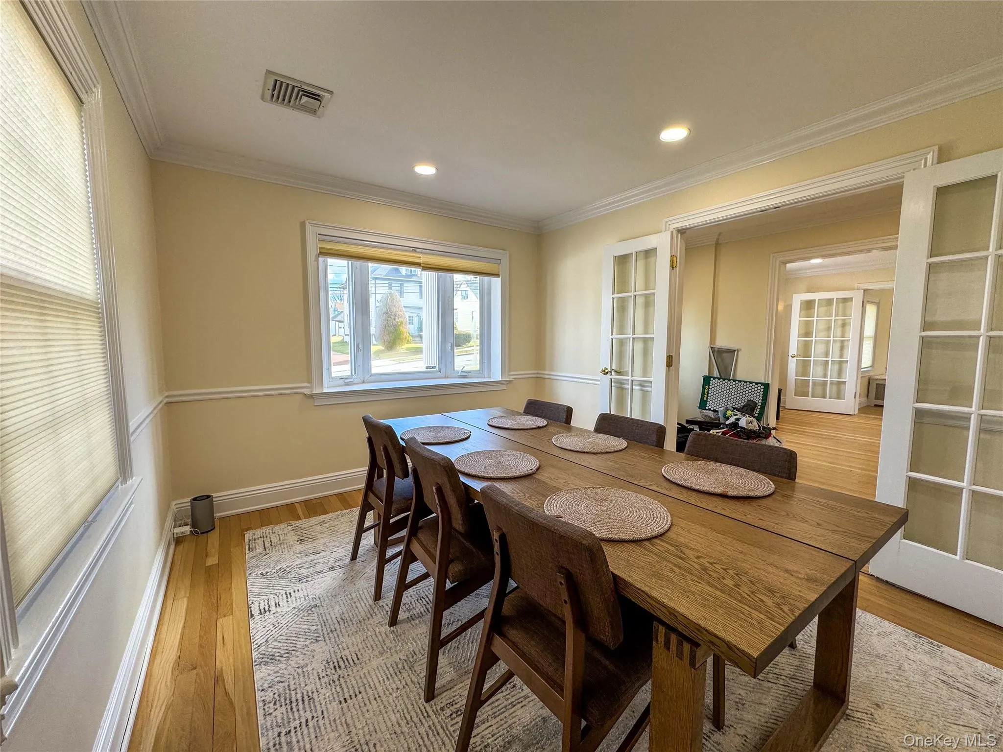 Hardwood flooring, recessed lighting, crown molding, chair rail molding, and French doors Hardwood flooring, recessed lighting, crown molding, chair rail molding, and French doors