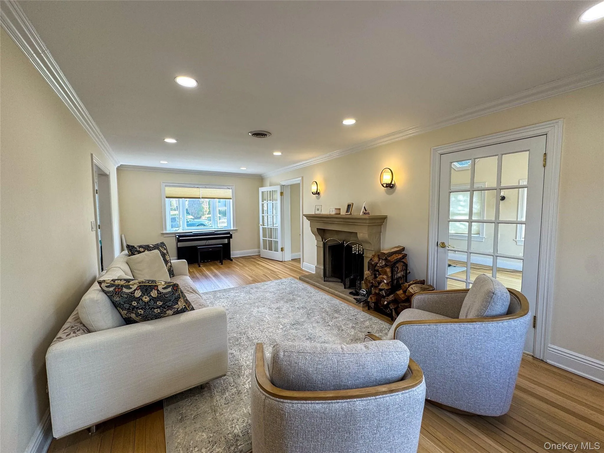 Recessed lighting, crown molding, wood-finish flooring, stone fireplace, and French doors Recessed lighting, crown molding, wood-finish flooring, stone fireplace, and French doors