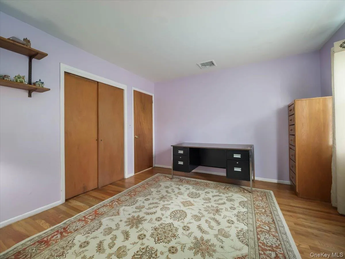 Hardwood flooring, wood-finish sliding closet doors, and wall-mounted shelving Hardwood flooring, wood-finish sliding closet doors, and wall-mounted shelving