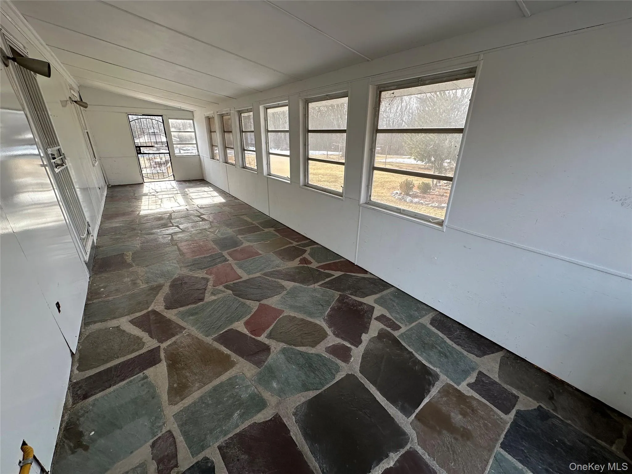 Sunroom off the kitchen in the back of the house Sunroom off the kitchen in the back of the house