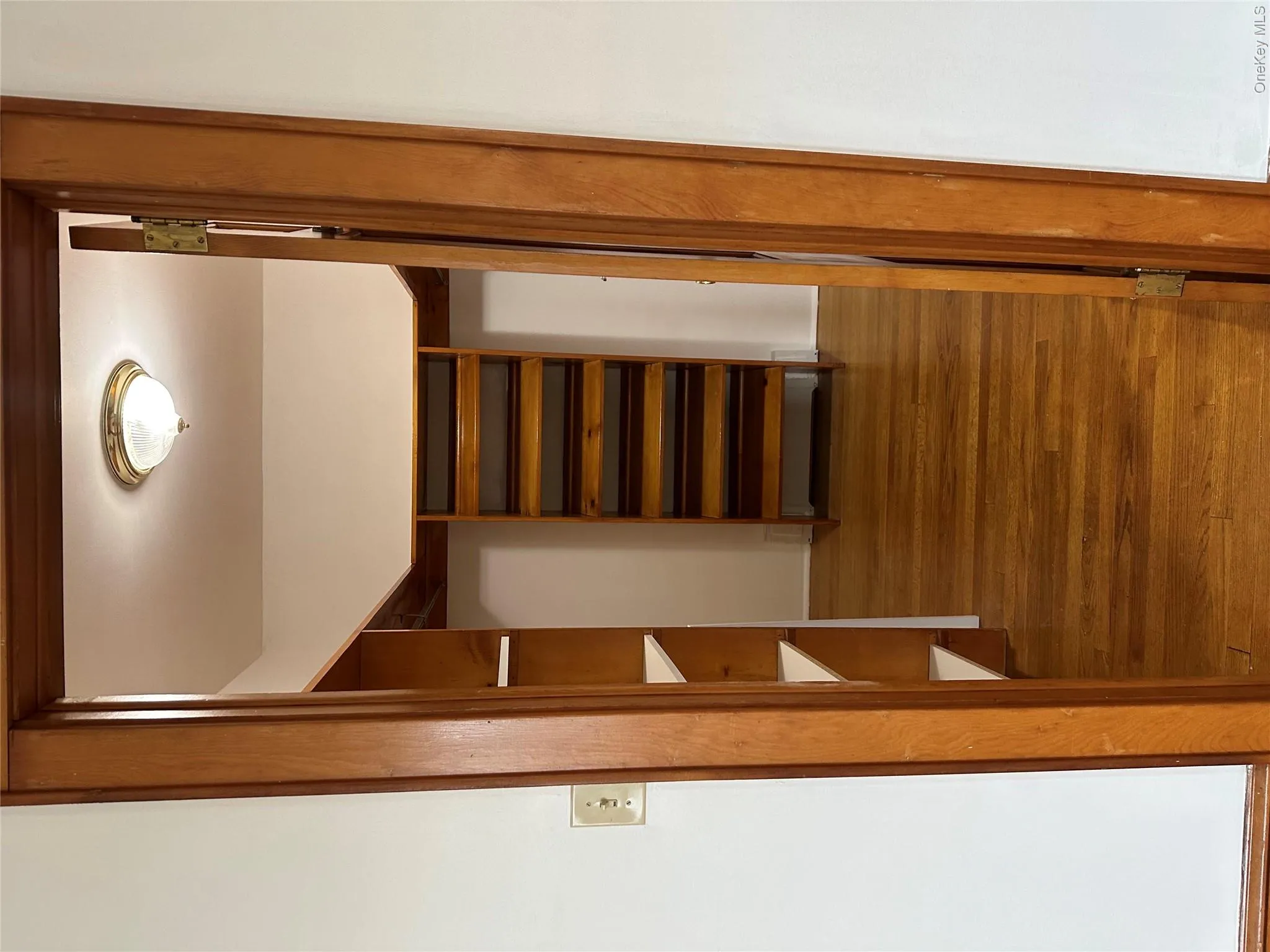 Spacious walk-in closet in primary bedroom featuring wood finished floors Spacious walk-in closet in primary bedroom featuring wood finished floors