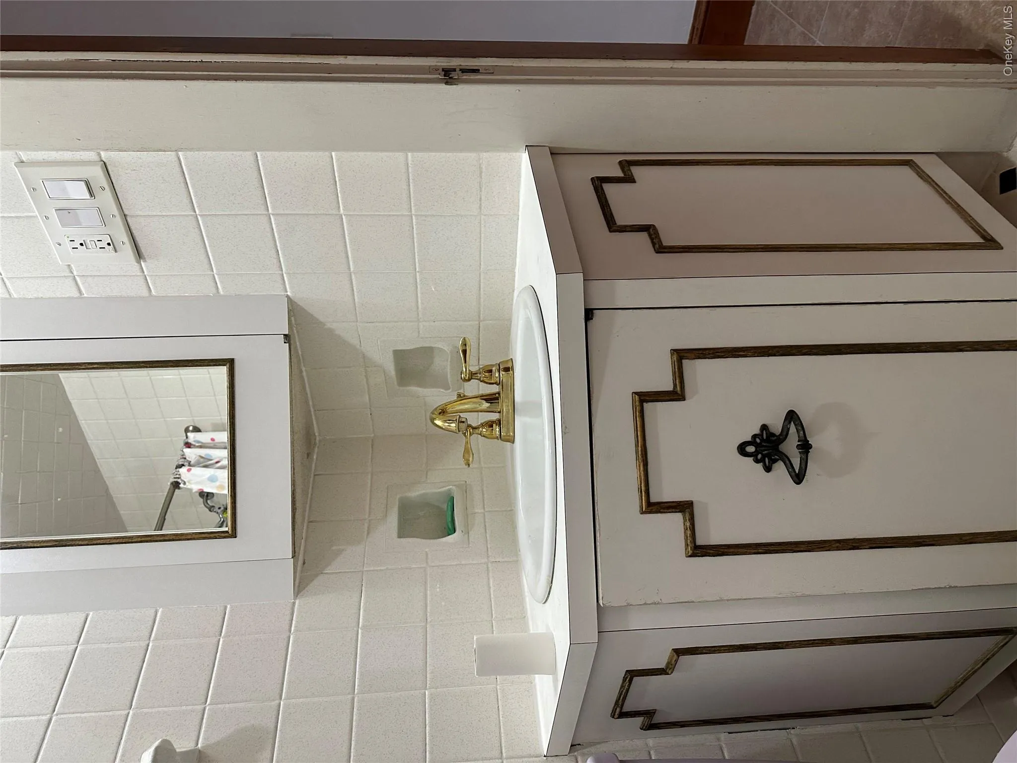 Bathroom featuring vanity and decorative backsplash Bathroom featuring vanity and decorative backsplash