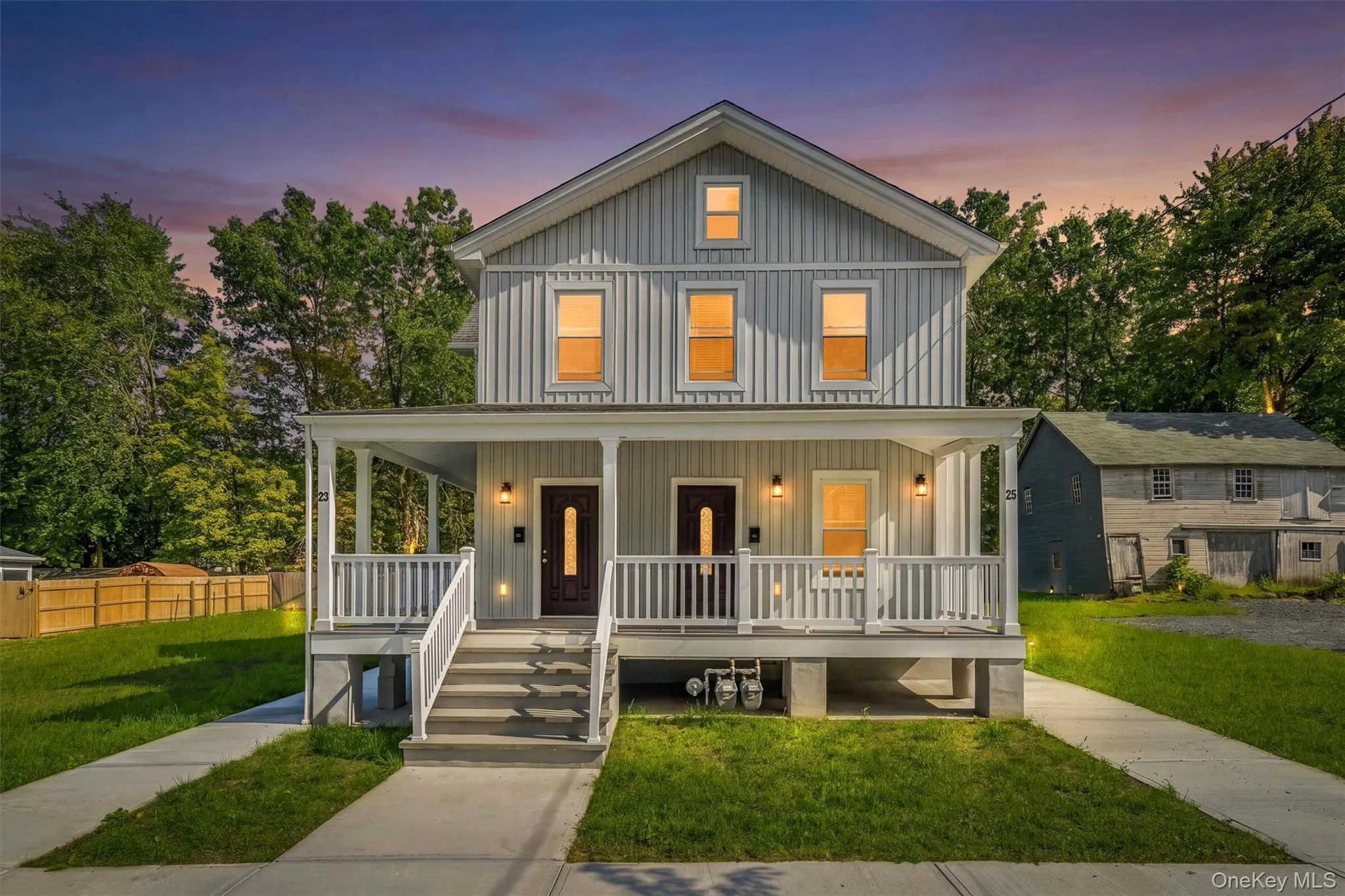 Two-story exterior with vertical siding, dual covered front porches, and separate entryways Two-story exterior with vertical siding, dual covered front porches, and separate entryways