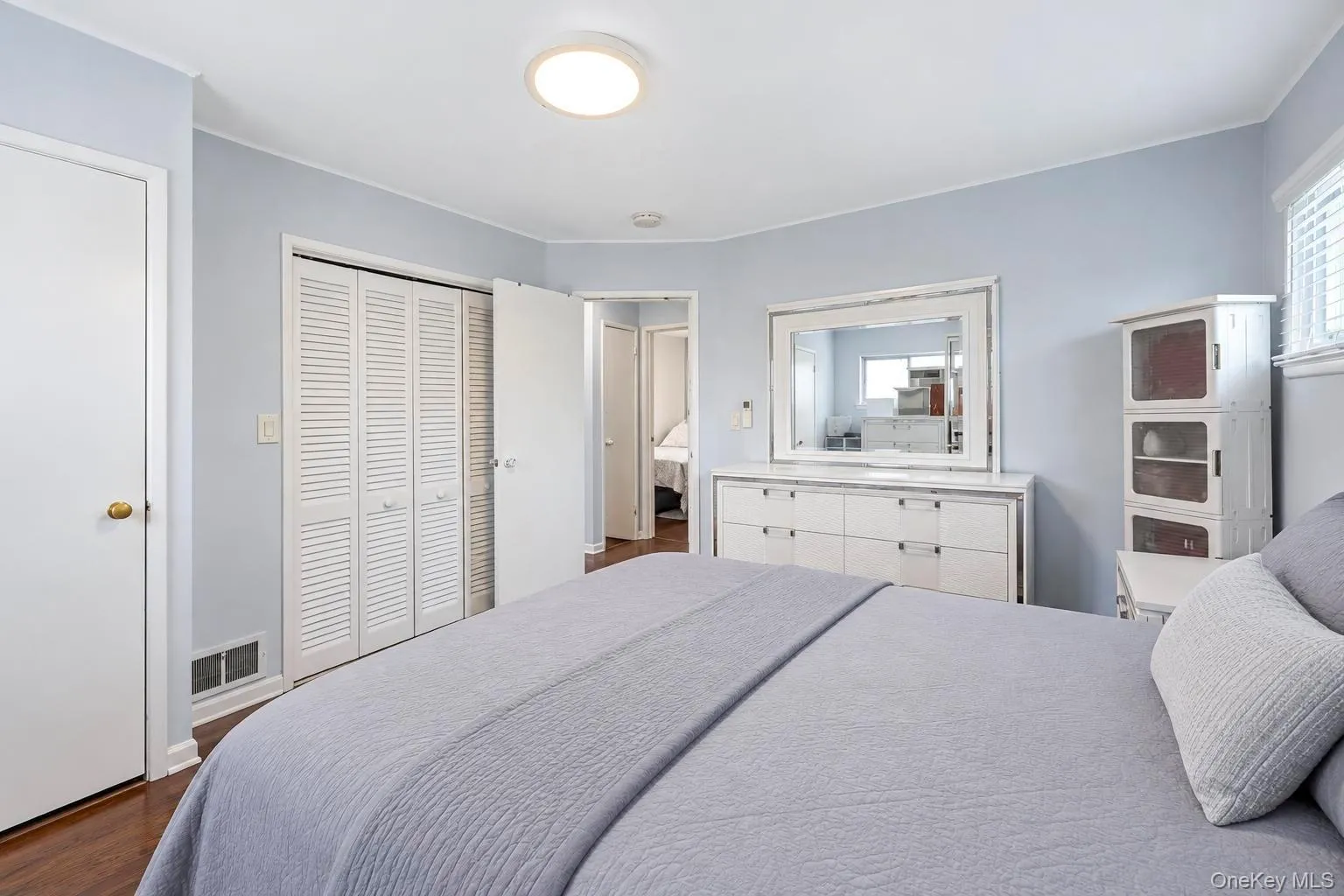 Hardwood-style flooring, louvered closet doors, and recessed lighting Hardwood-style flooring, louvered closet doors, and recessed lighting