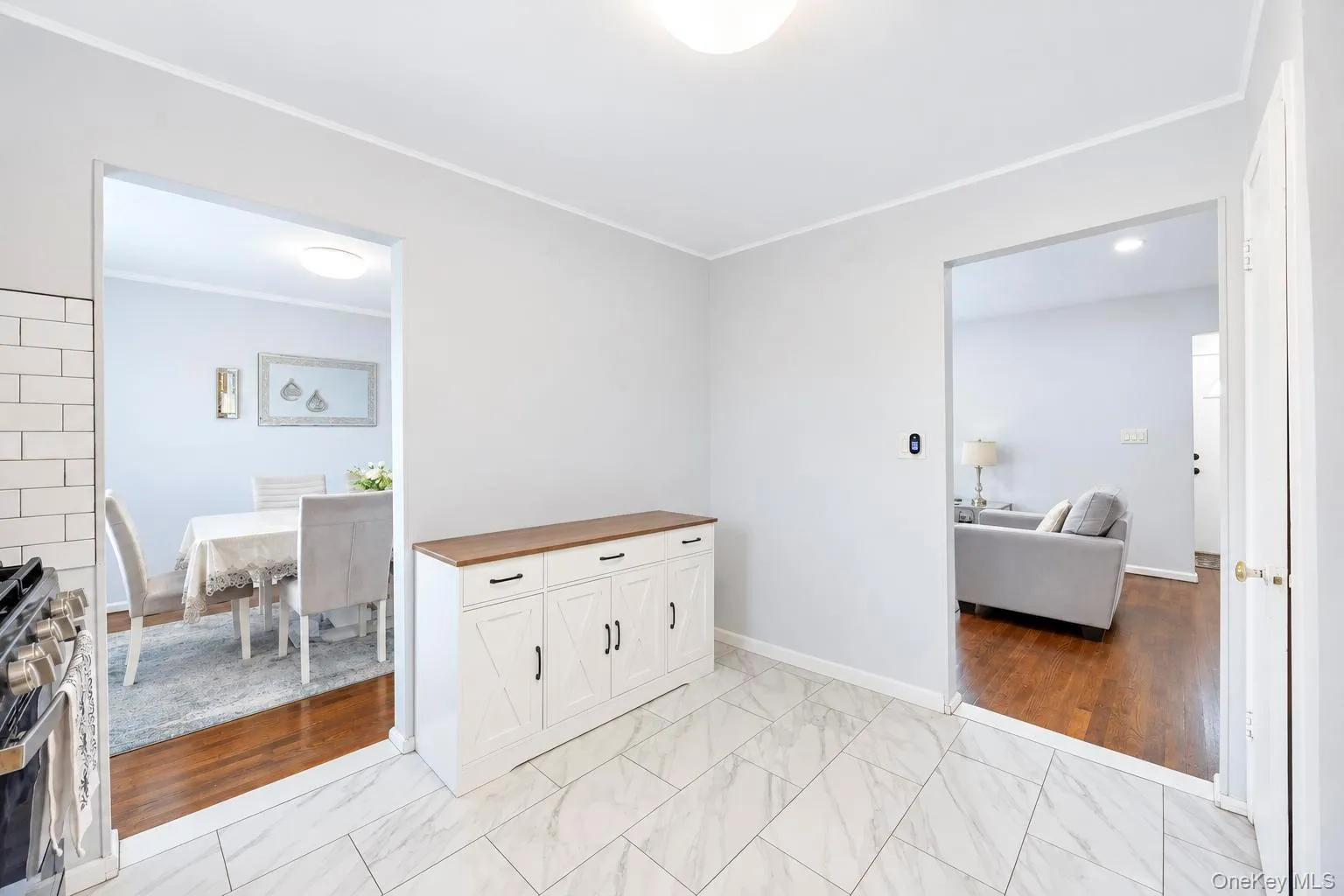 White subway tile backsplash, white wall paint, white ceiling, and a light fixture White subway tile backsplash, white wall paint, white ceiling, and a light fixture