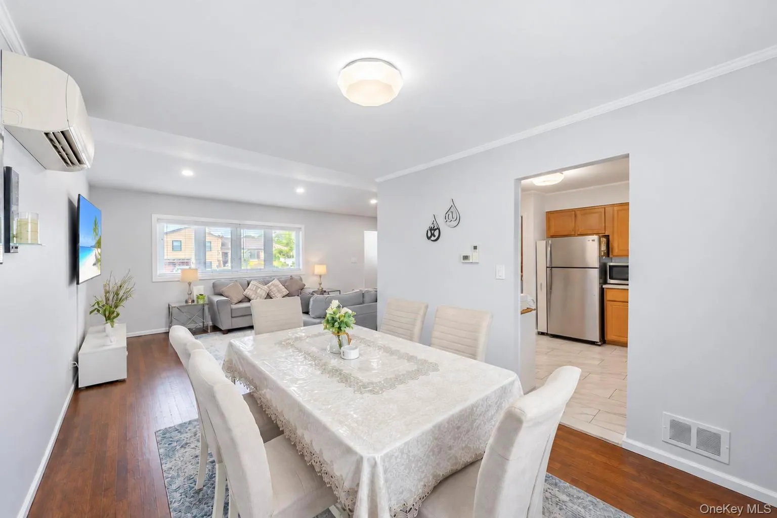 Wood-finish flooring throughout, recessed lighting, and a kitchen with wood cabinetry and stainless steel appliances Wood-finish flooring throughout, recessed lighting, and a kitchen with wood cabinetry and stainless steel appliances