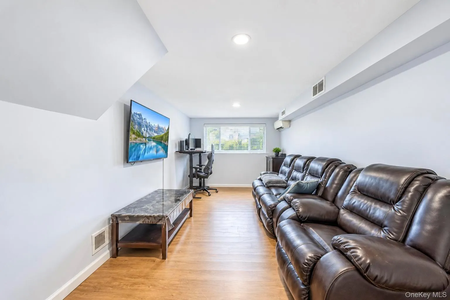 Wood-finish flooring with recessed lighting and a window Wood-finish flooring with recessed lighting and a window