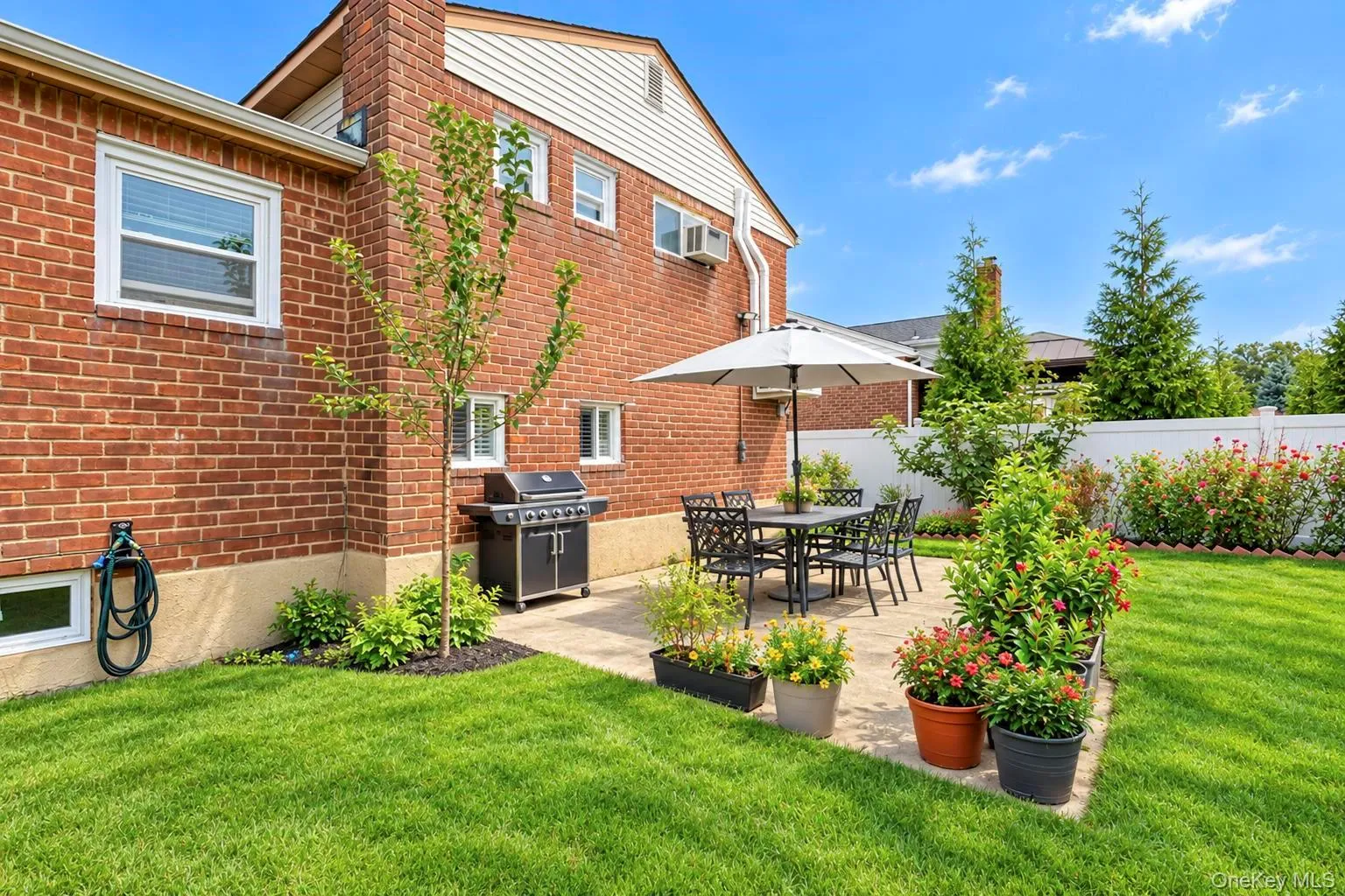 Brick exterior with white trim windows and a private patio Brick exterior with white trim windows and a private patio