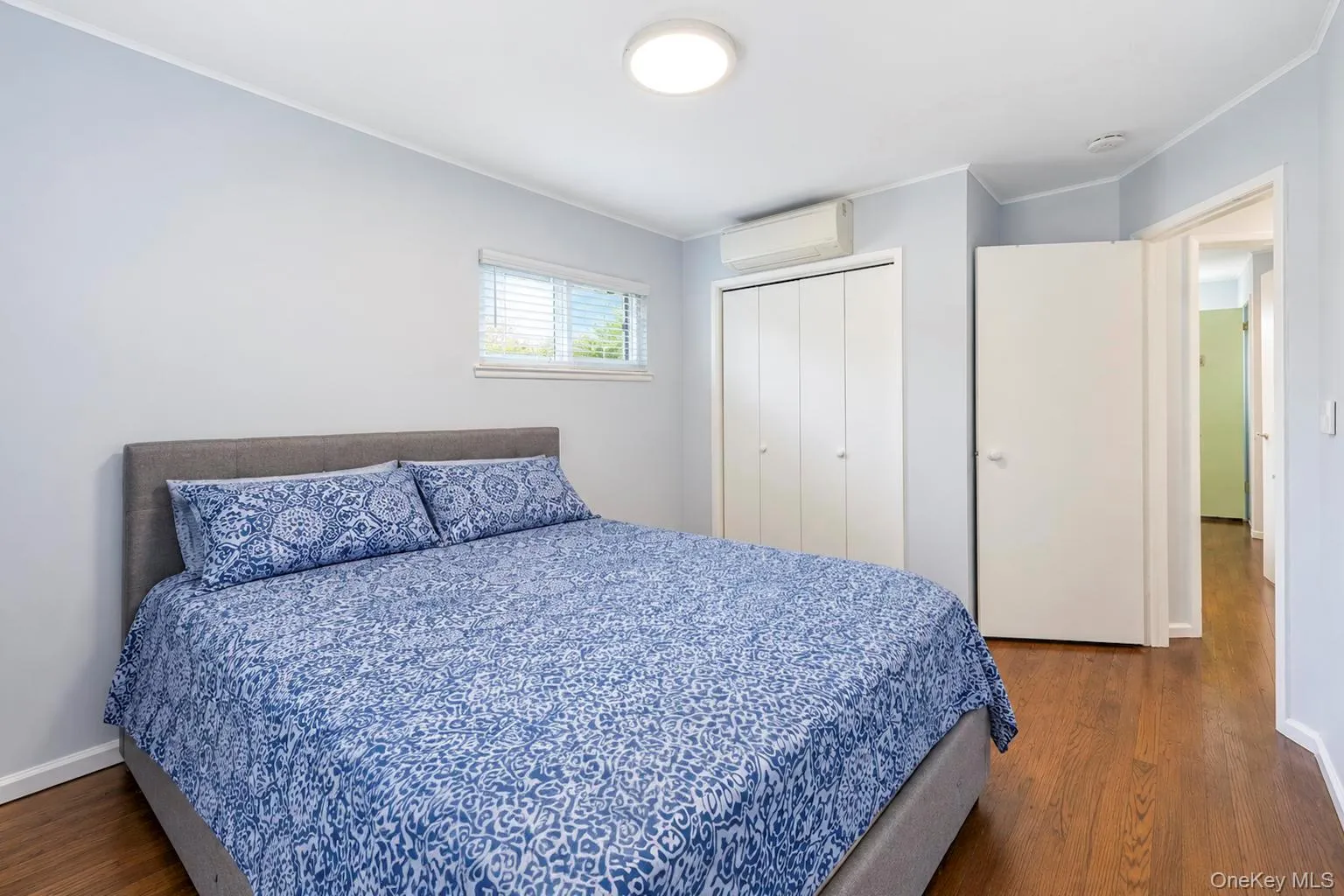 Wood-finish flooring, white bi-fold closet doors, and recessed lighting Wood-finish flooring, white bi-fold closet doors, and recessed lighting
