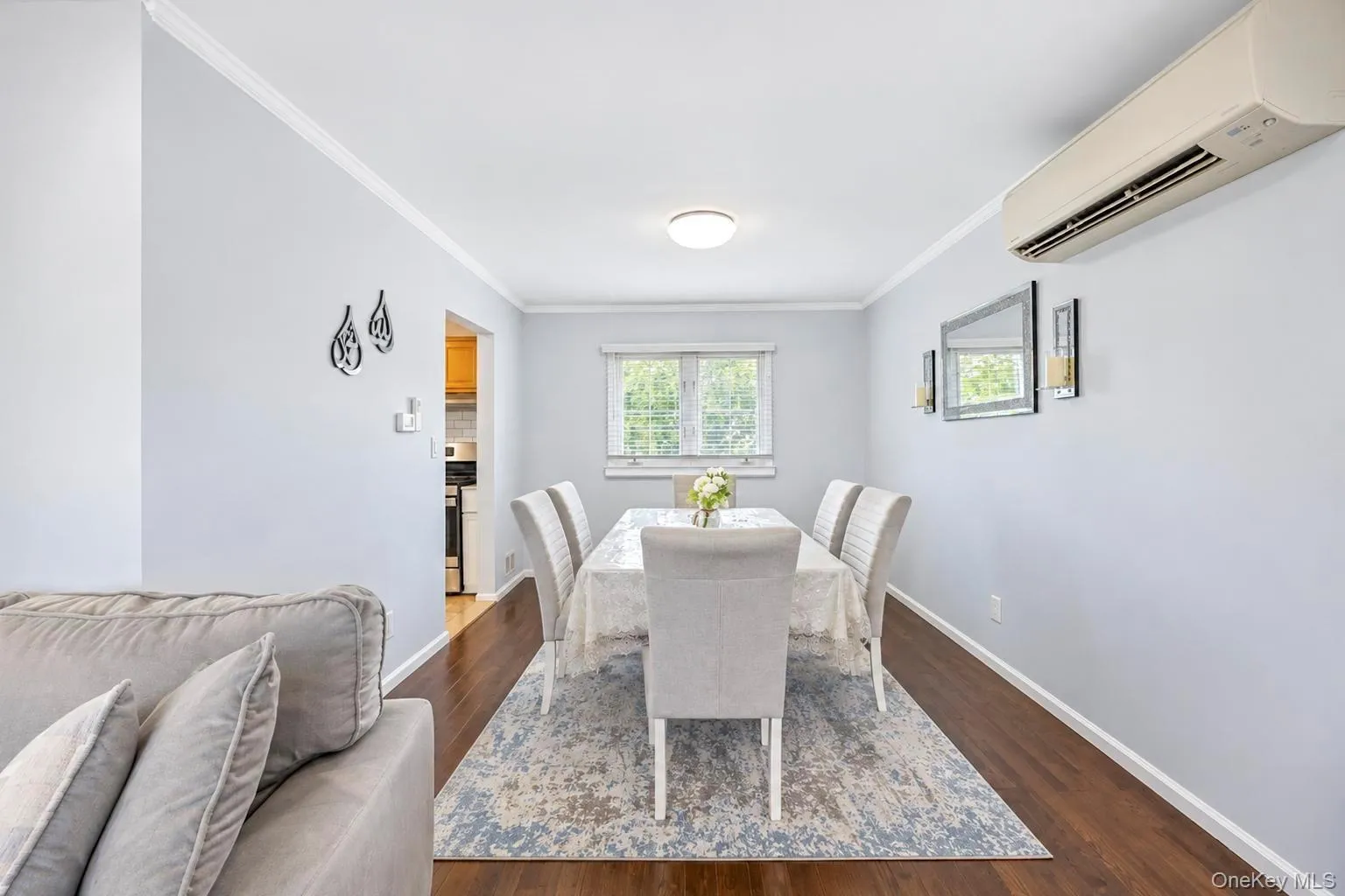 Bright dining area with recessed ceiling lighting, large multi-pane windows providing natural light, wood-finish flooring, and a neutral color palette Bright dining area with recessed ceiling lighting, large multi-pane windows providing natural light, wood-finish flooring, and a neutral color palette