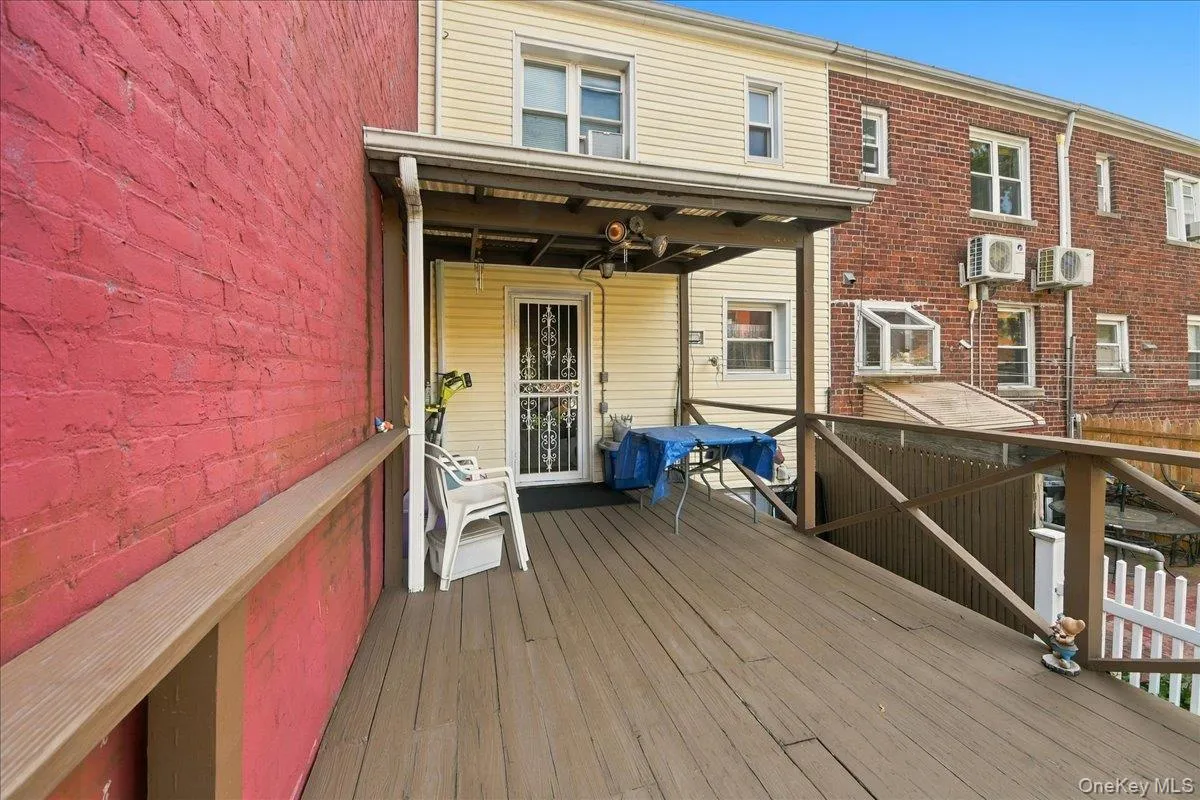 Expansive wooden deck with a covered outdoor area, providing access to the property's exterior Expansive wooden deck with a covered outdoor area, providing access to the property's exterior