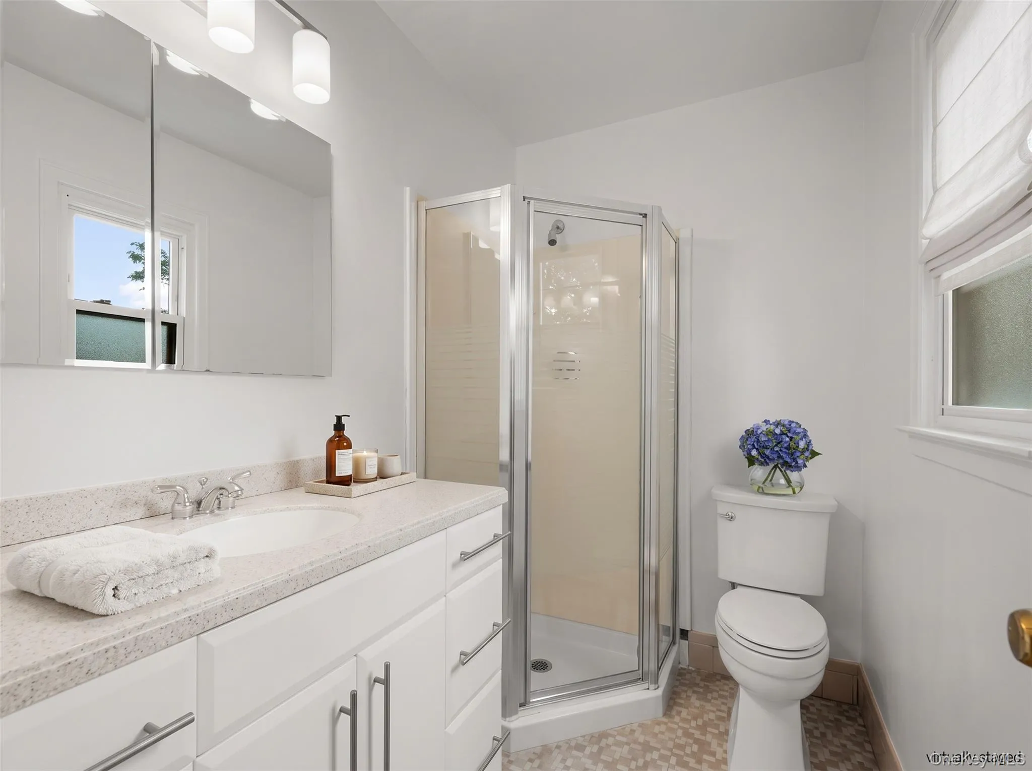 A private en-suite bathroom with stall shower. A private en-suite bathroom with stall shower.