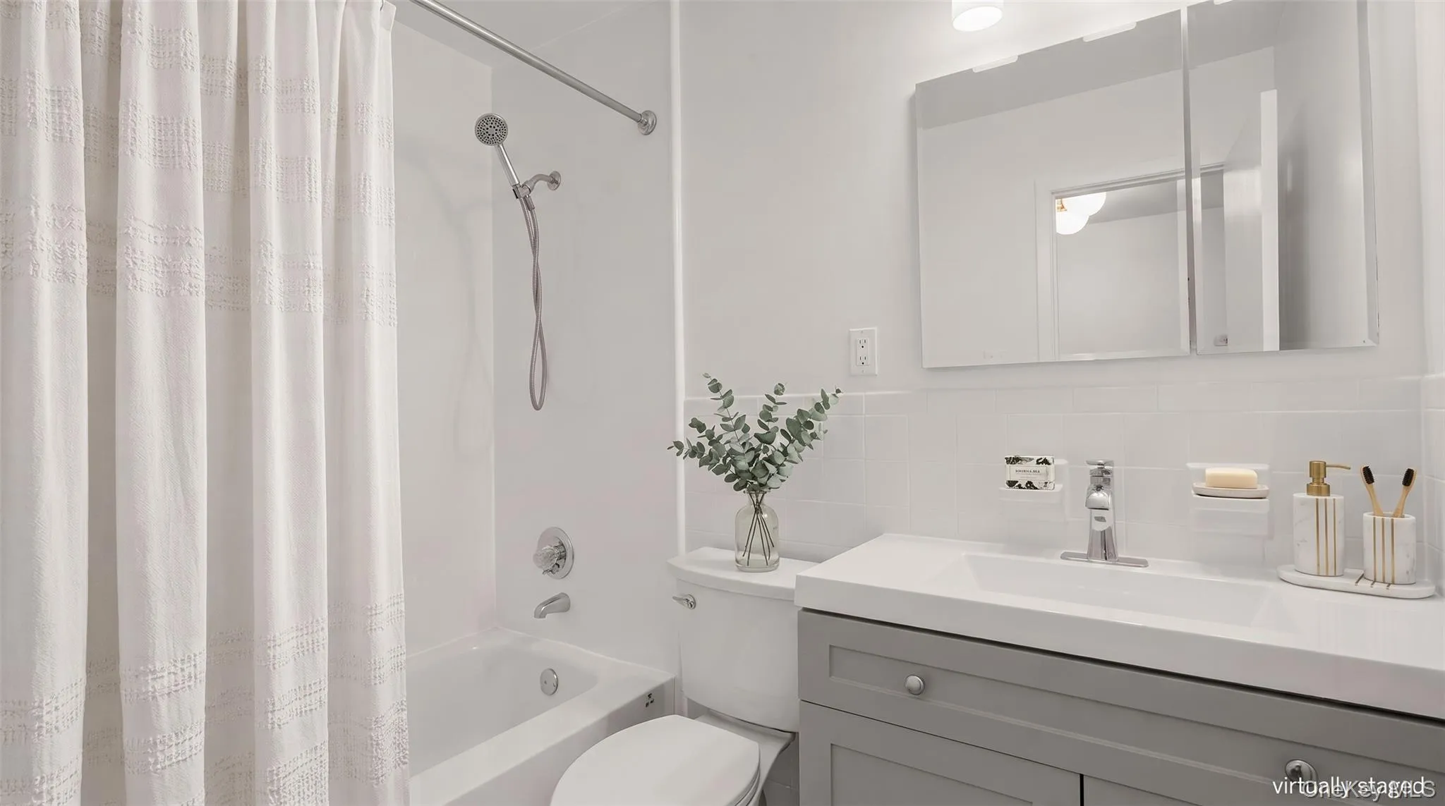 Refreshed hall bath features a modern vanity and updated fixtures. Refreshed hall bath features a modern vanity and updated fixtures.