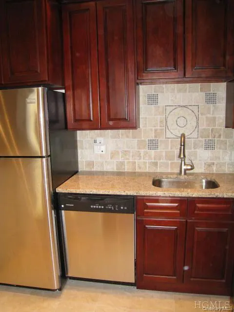 New Kitchen with Granite Counters, Stainless Steel Appliances, Cherry Cabinets and tumble tile back splash. The kitchen is open to the living room allowing plenty of light. New Kitchen with Granite Counters, Stainless Steel Appliances, Cherry Cabinets and tumble tile back splash. The kitchen is open to the living room allowing plenty of light.