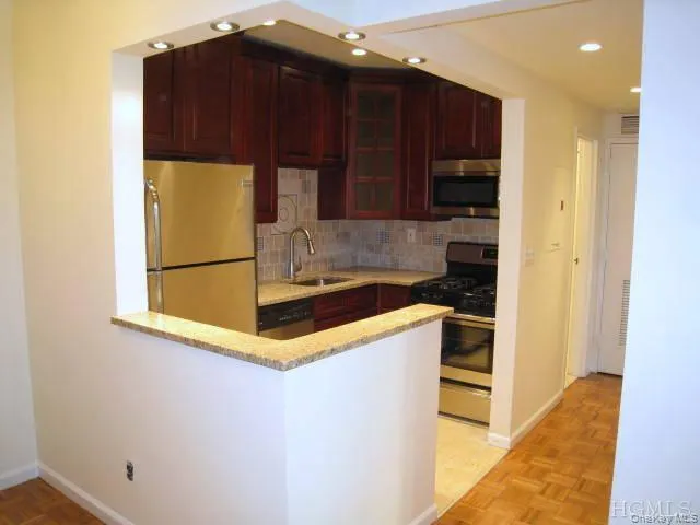 New Kitchen with Granite Counters, Stainless Steel Appliances, Cherry Cabinets and tumble tile back splash. The kitchen is open to the living room allowing plenty of light. New Kitchen with Granite Counters, Stainless Steel Appliances, Cherry Cabinets and tumble tile back splash. The kitchen is open to the living room allowing plenty of light.
