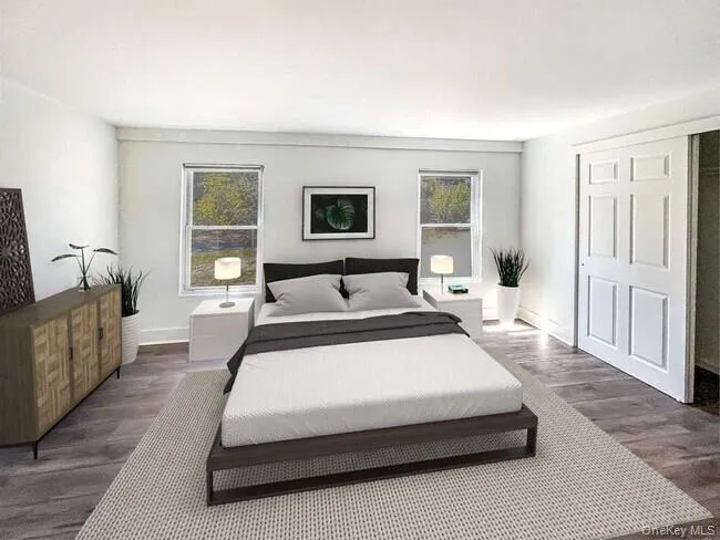 Wood-finish flooring, white walls, and a sliding panel door closet Wood-finish flooring, white walls, and a sliding panel door closet