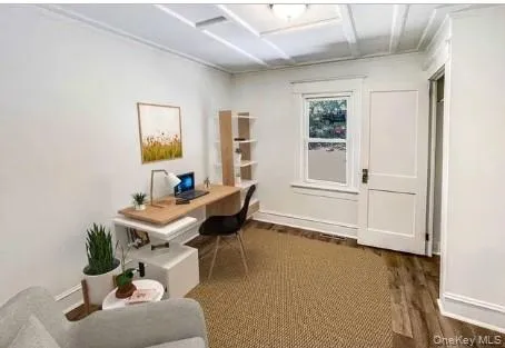 Wainscoting ceiling, wood-finish flooring, white trim, white paneled door, and a single window Wainscoting ceiling, wood-finish flooring, white trim, white paneled door, and a single window