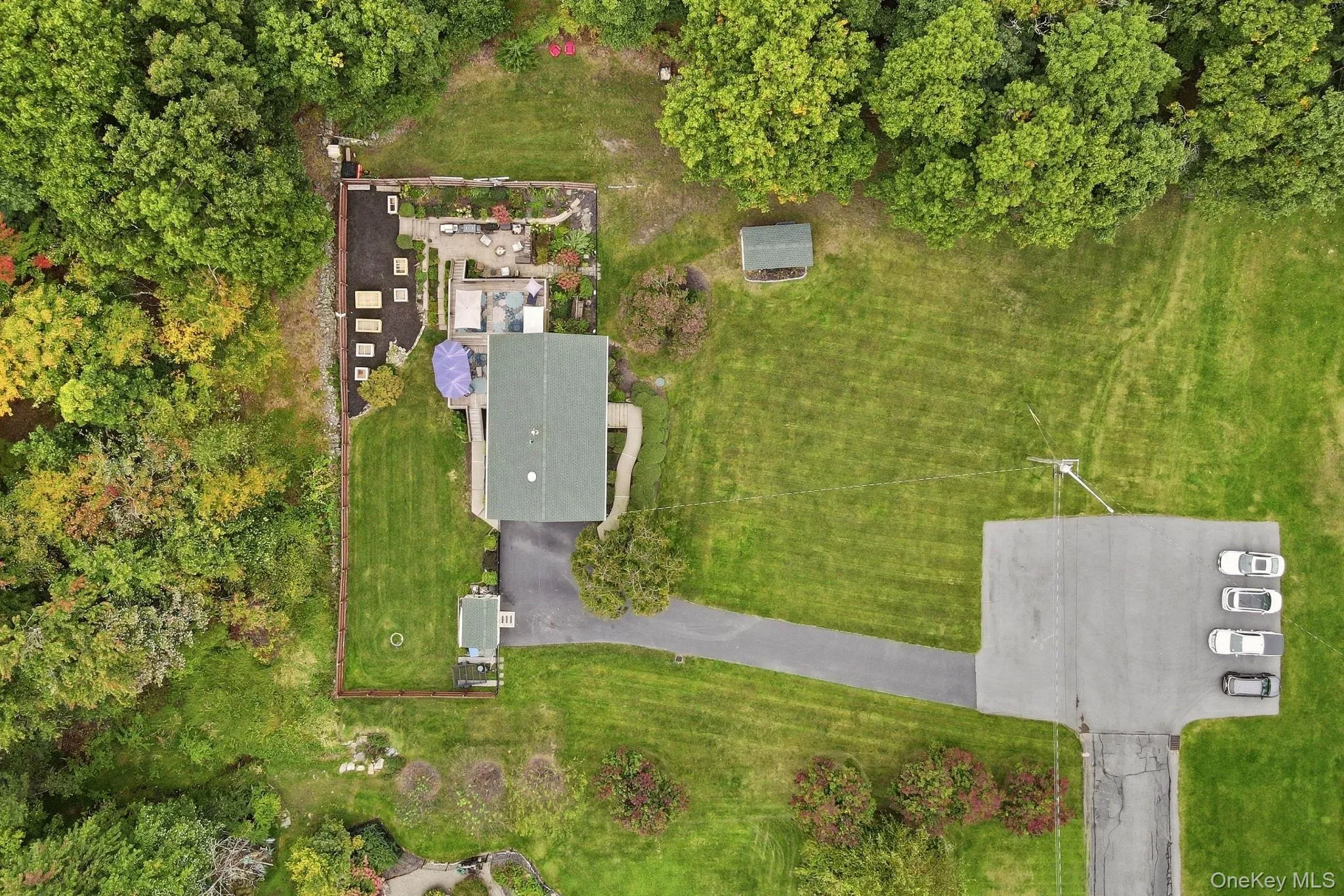 A wider perspective highlights the home's setting and surrounding grounds. A wider perspective highlights the home's setting and surrounding grounds.