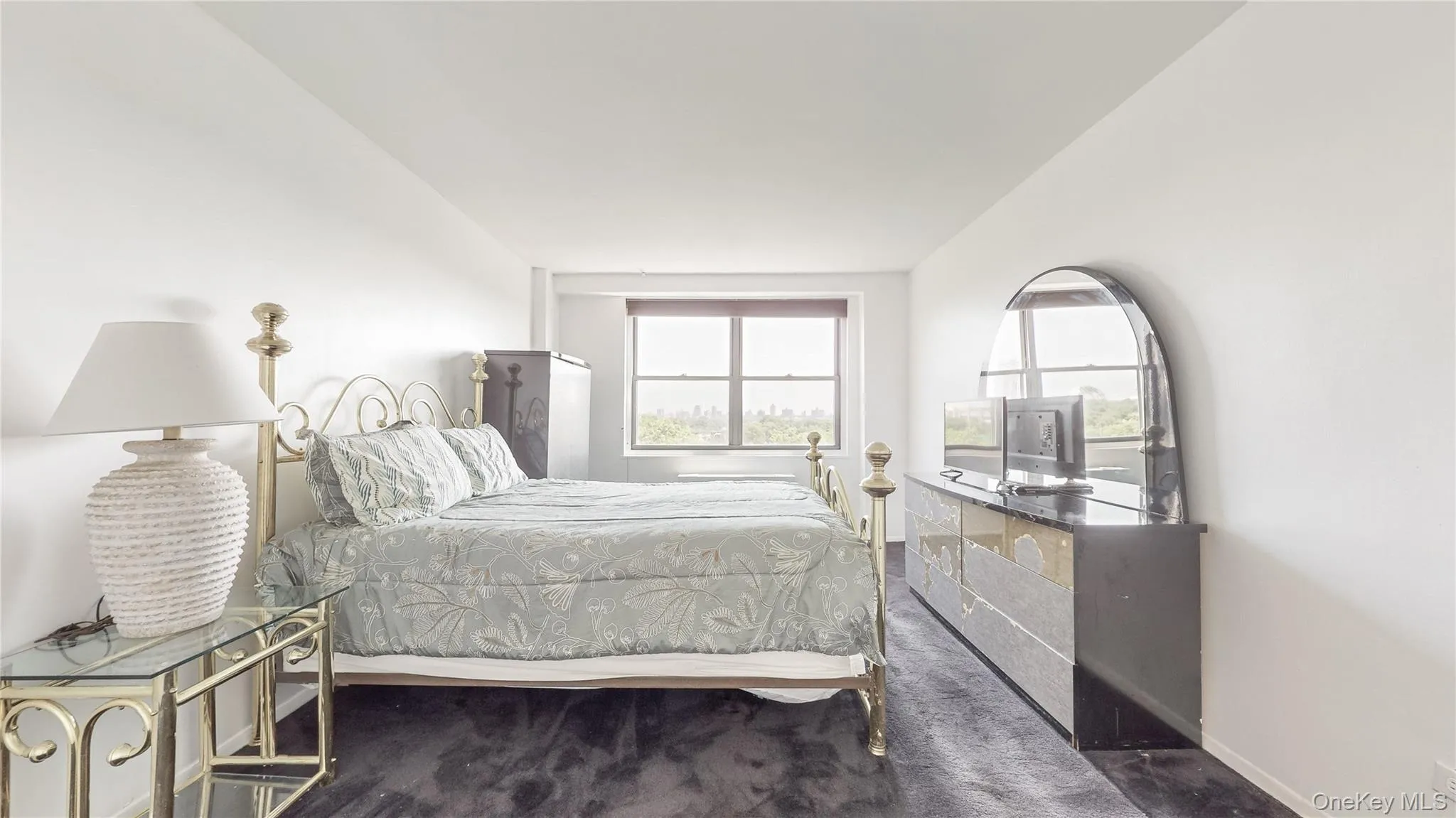 Expansive wall-to-wall carpeting, large window with ample natural light, and a bright white wall finish Expansive wall-to-wall carpeting, large window with ample natural light, and a bright white wall finish