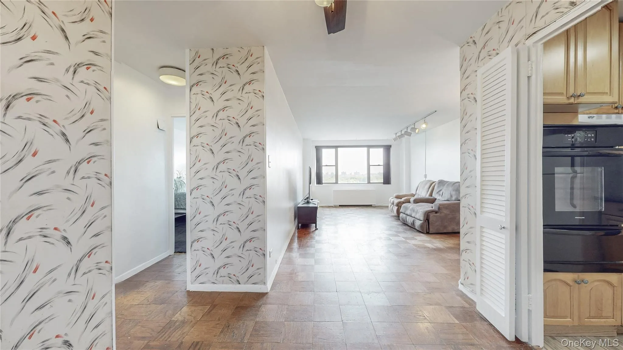 Wood-finish flooring throughout, track lighting, and a built-in double oven Wood-finish flooring throughout, track lighting, and a built-in double oven