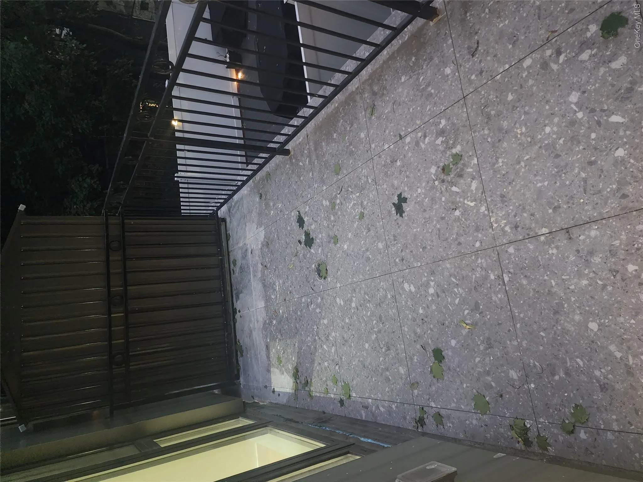 Terrace featuring large format stone-finish tile flooring, painted metal railings. Terrace featuring large format stone-finish tile flooring, painted metal railings.