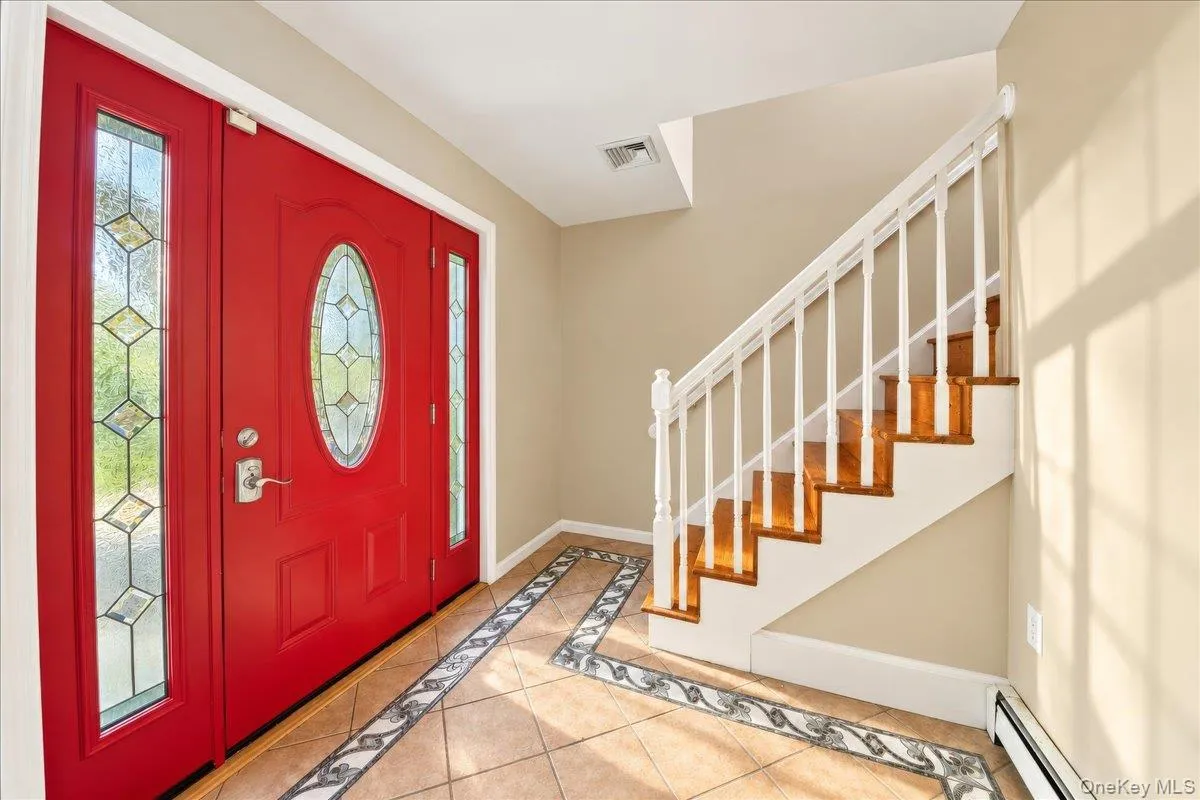Red entry door with an oval leaded glass insert Red entry door with an oval leaded glass insert
