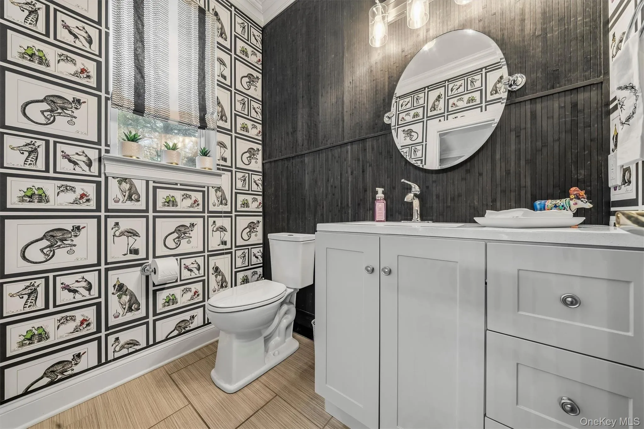 The main floor oversized half bath with designer wall treatments. The main floor oversized half bath with designer wall treatments.