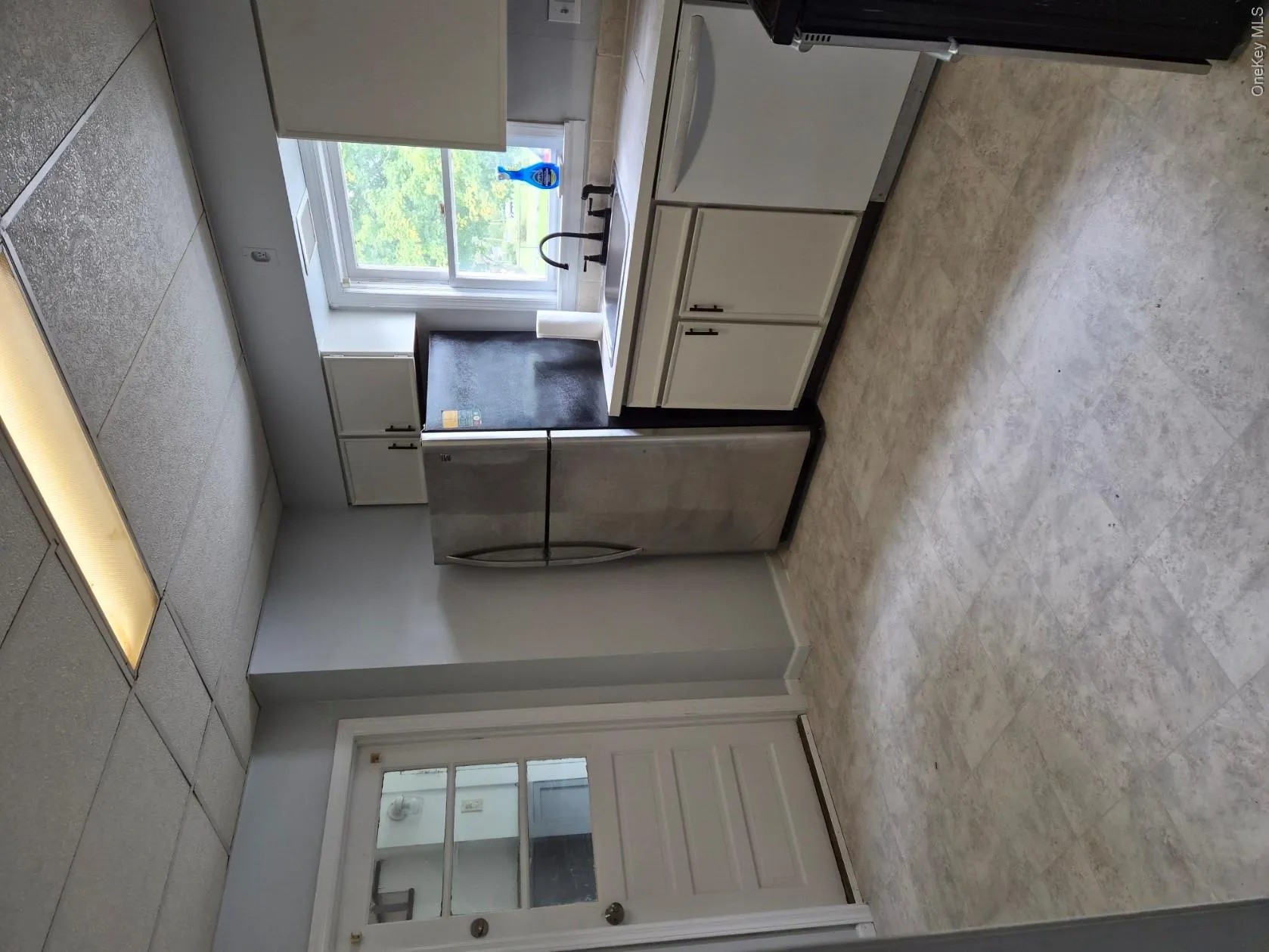 Eat-In Kitchen with back door leading to community hallway and laundry room Eat-In Kitchen with back door leading to community hallway and laundry room