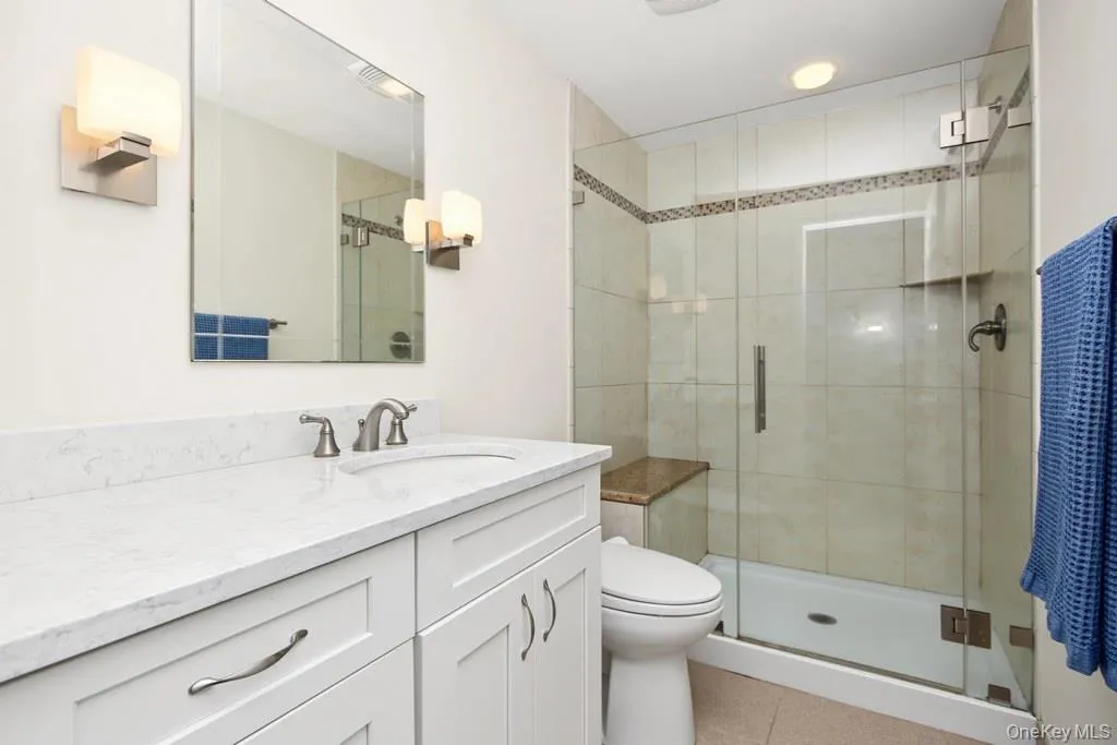 Bathroom on lower level has a stall shower with glass door and seating Bathroom on lower level has a stall shower with glass door and seating